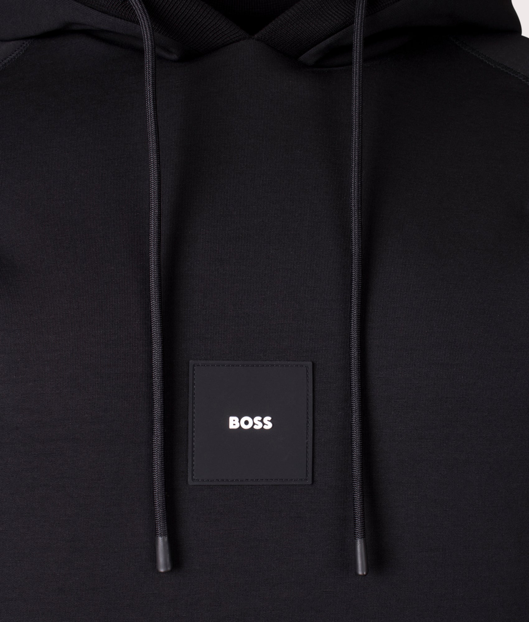 BOSS Soody Rib Hoodie in Black. Shot at EQVVS. Front logo shot
