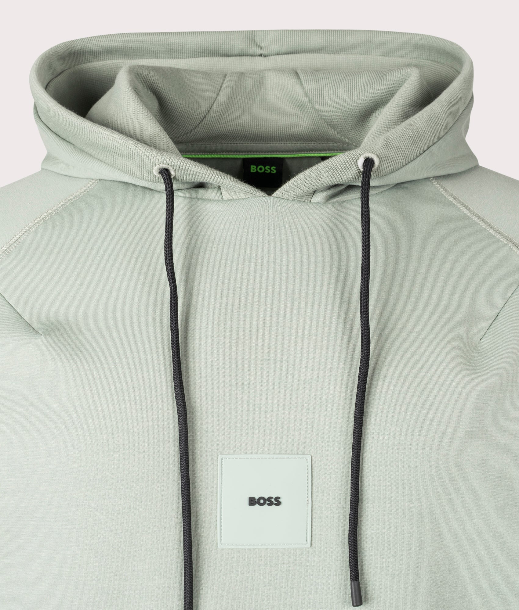BOSS Soody Rib Hoodie in Open Green . Shot at EQVVS. Front centre logo shot 