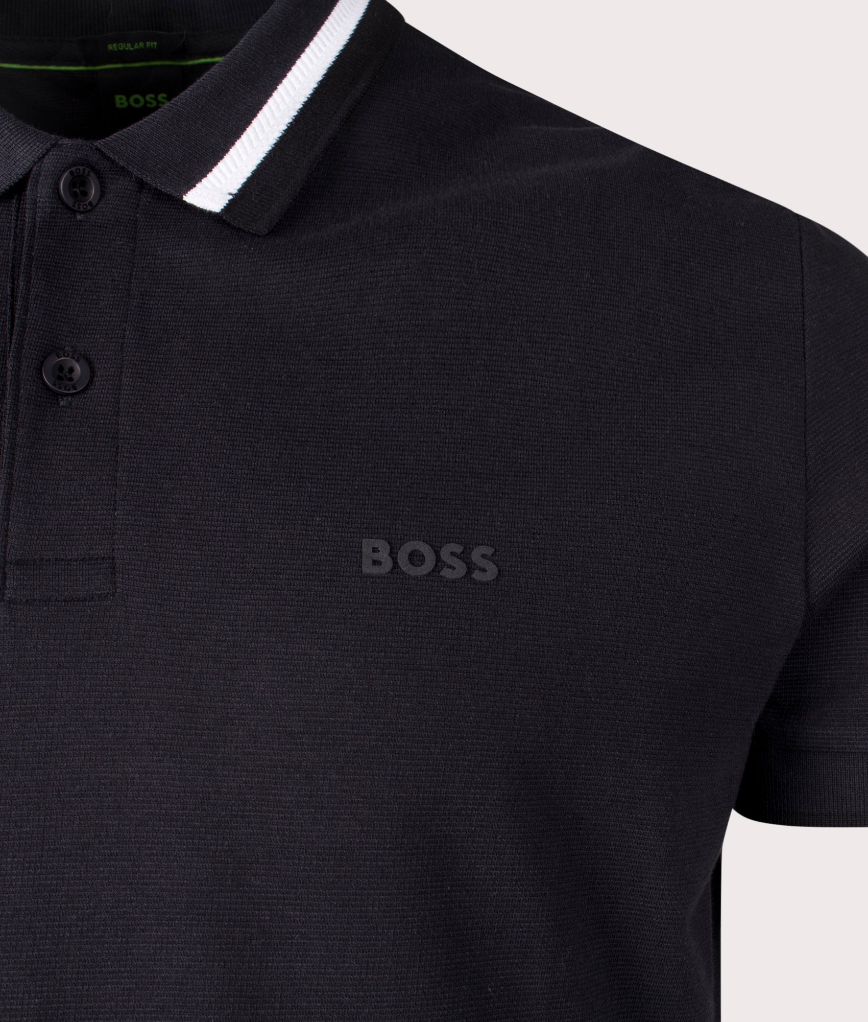 BOSS Paddy Active Polo Heritage Polo Shirt in Black. Shot at EQVVS. Front logo shot 