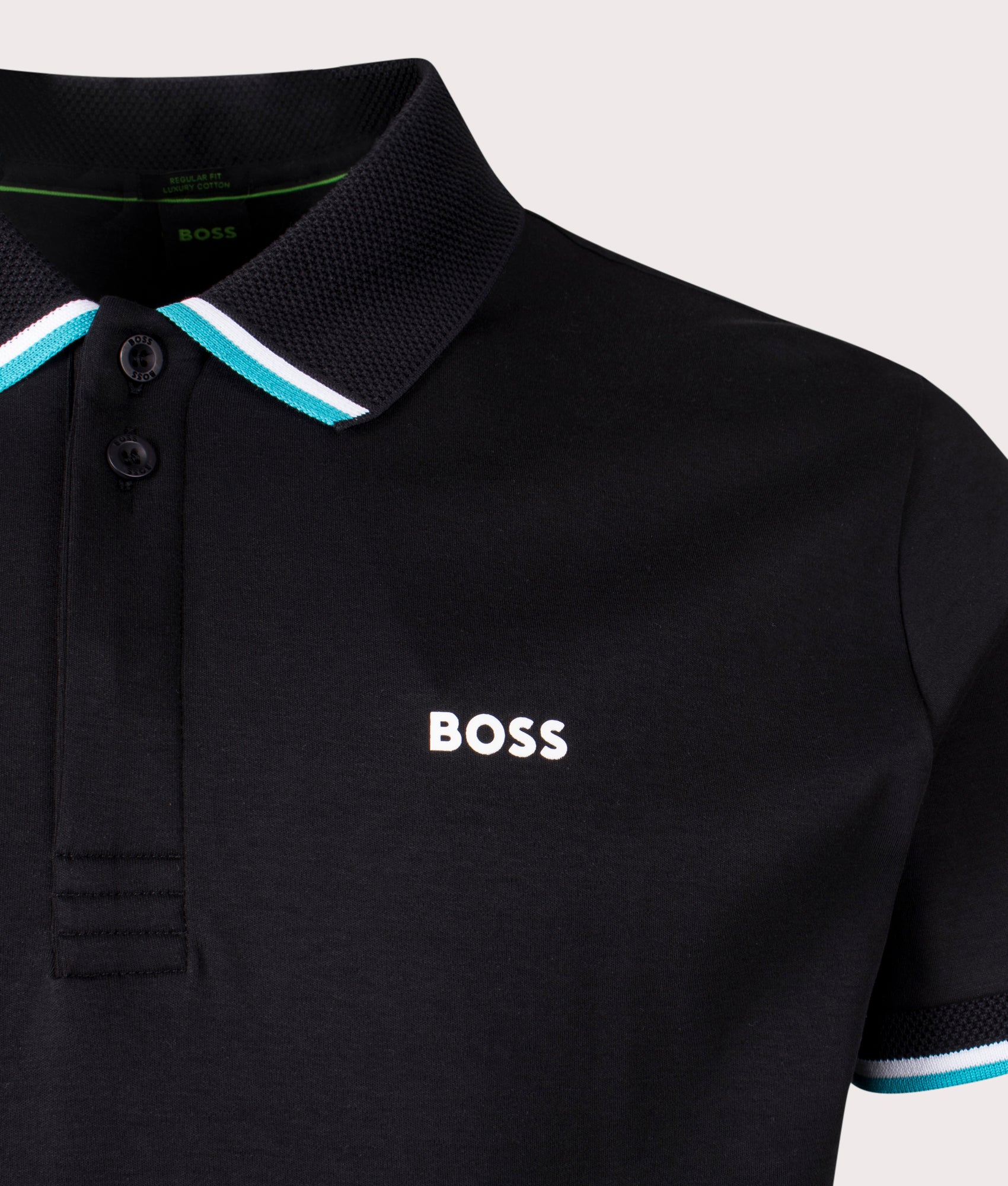 BOSS Paddy Lux Heritage Polo Shirt in Black. Shot at EQVVS. Front logo shot 