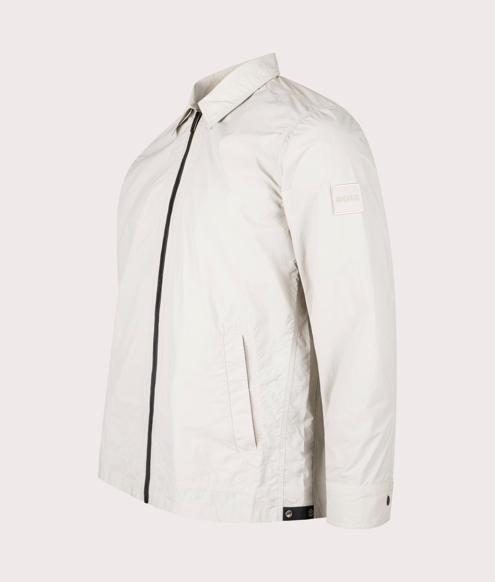 BOSS Oversized Leejay Zip Overshirt in Light Beige at EQVVS. Angle Shot.