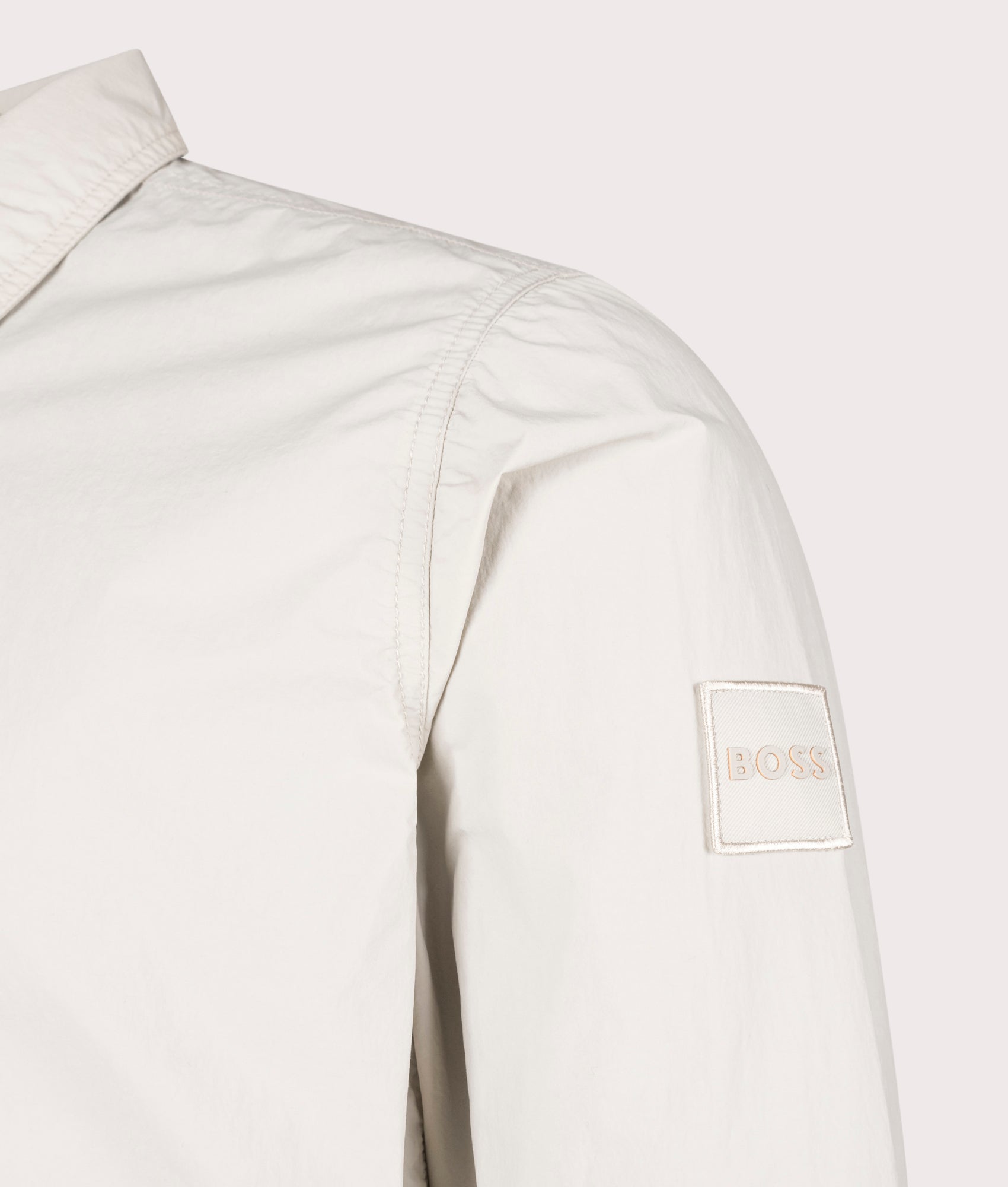 BOSS Oversized Leejay Zip Overshirt in Light Beige at EQVVS. Detail Shot.