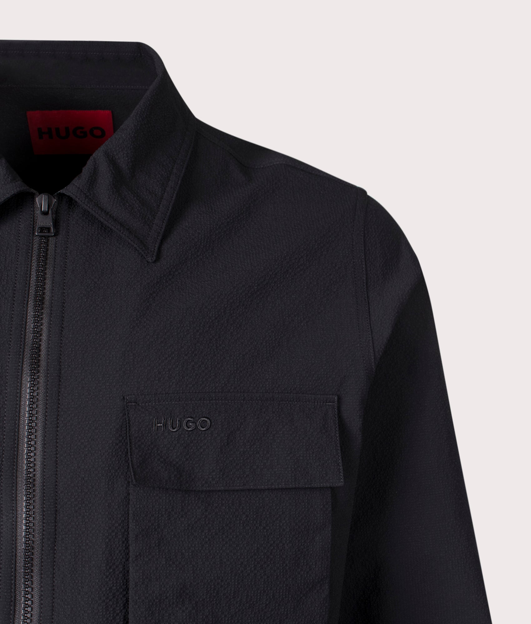 HUGO Oversized Eselio Zip Overshirt in Black at EQVVS. Close-up shot. 