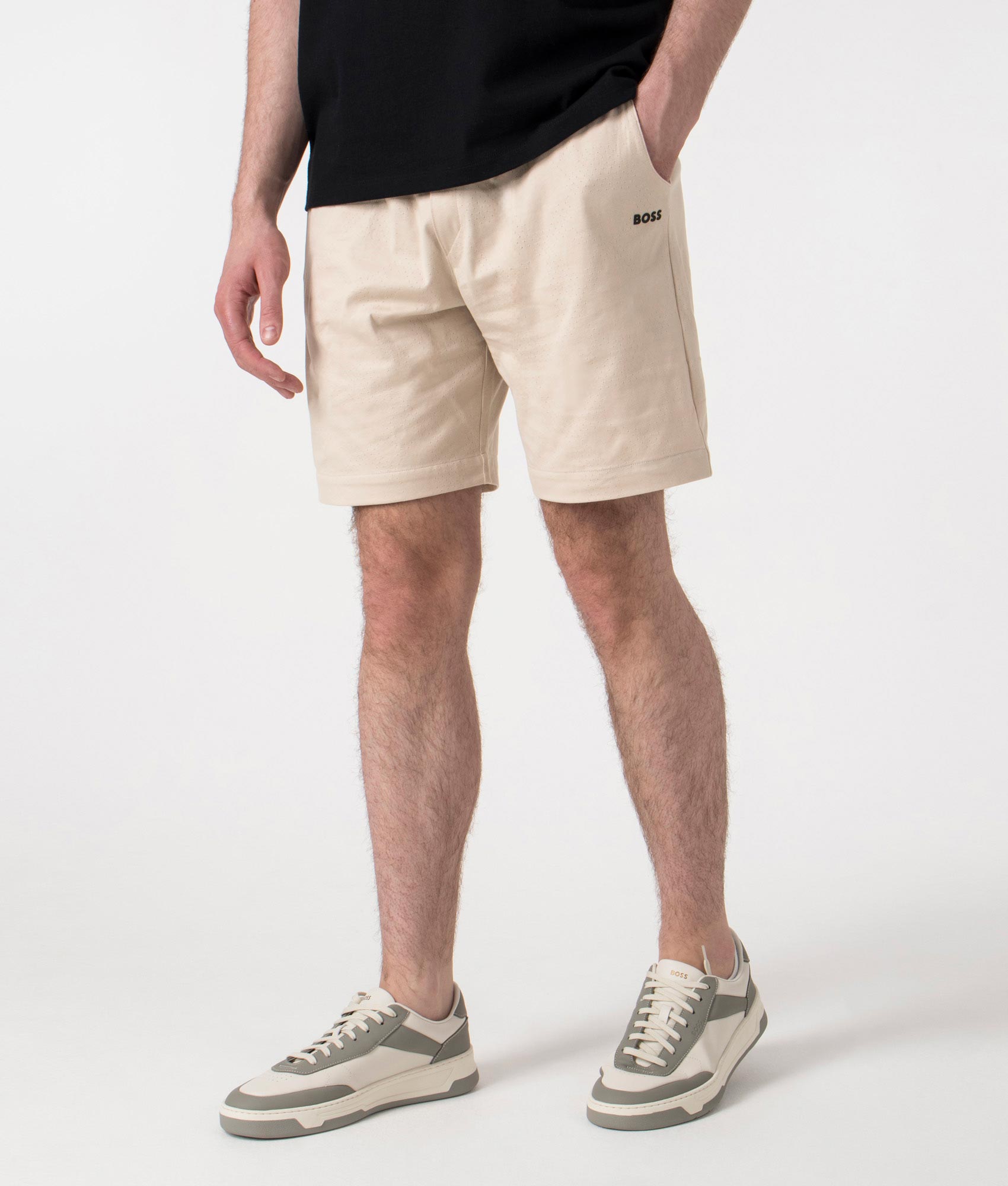BOSS Relaxed Fit Mesh Heritage Shorts in Open Beige at EQVVS. Angle Shot.