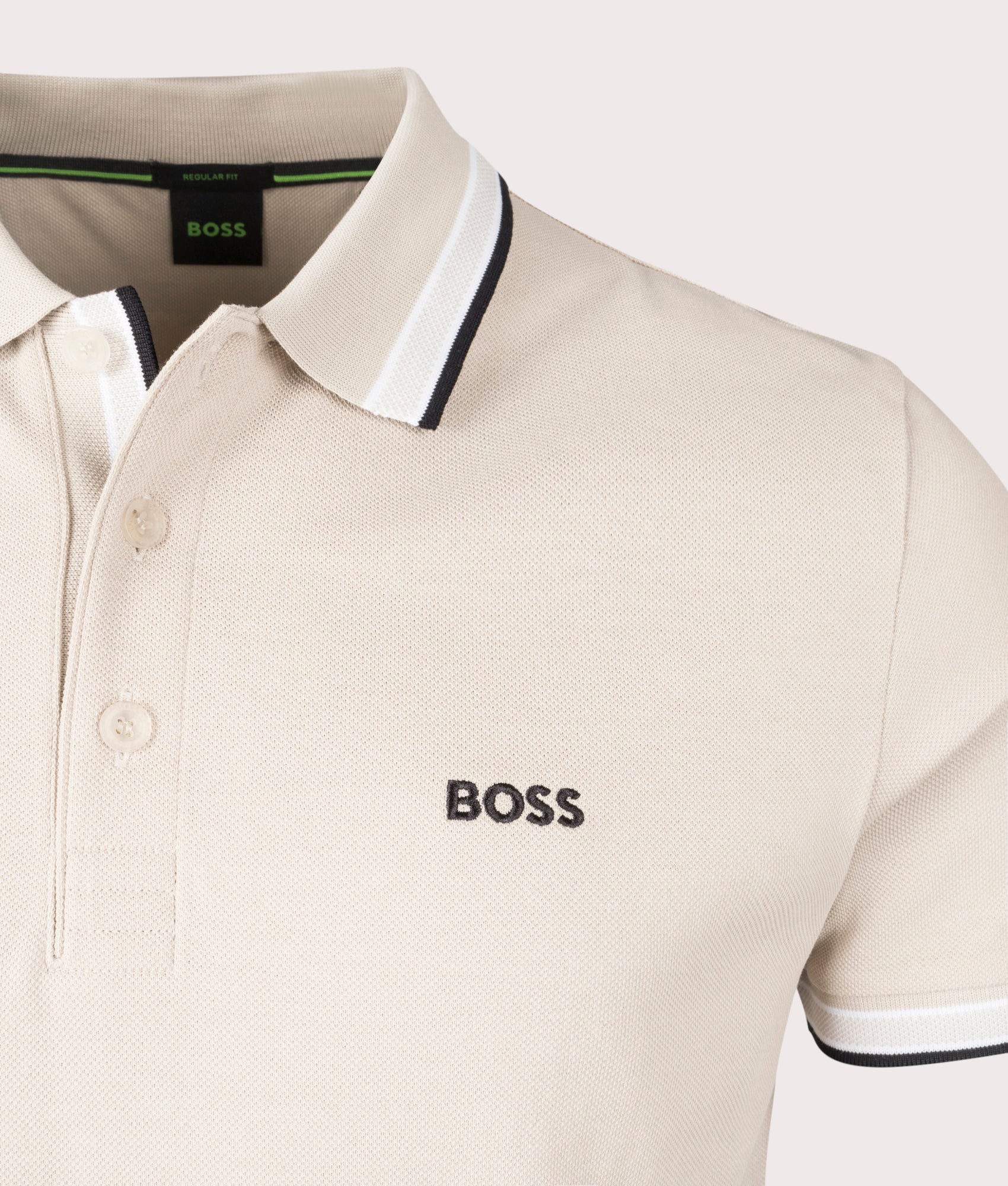 BOSS Paddy Polo Shirt in Open Beige. Shot at EQVVS. Front logo shot 