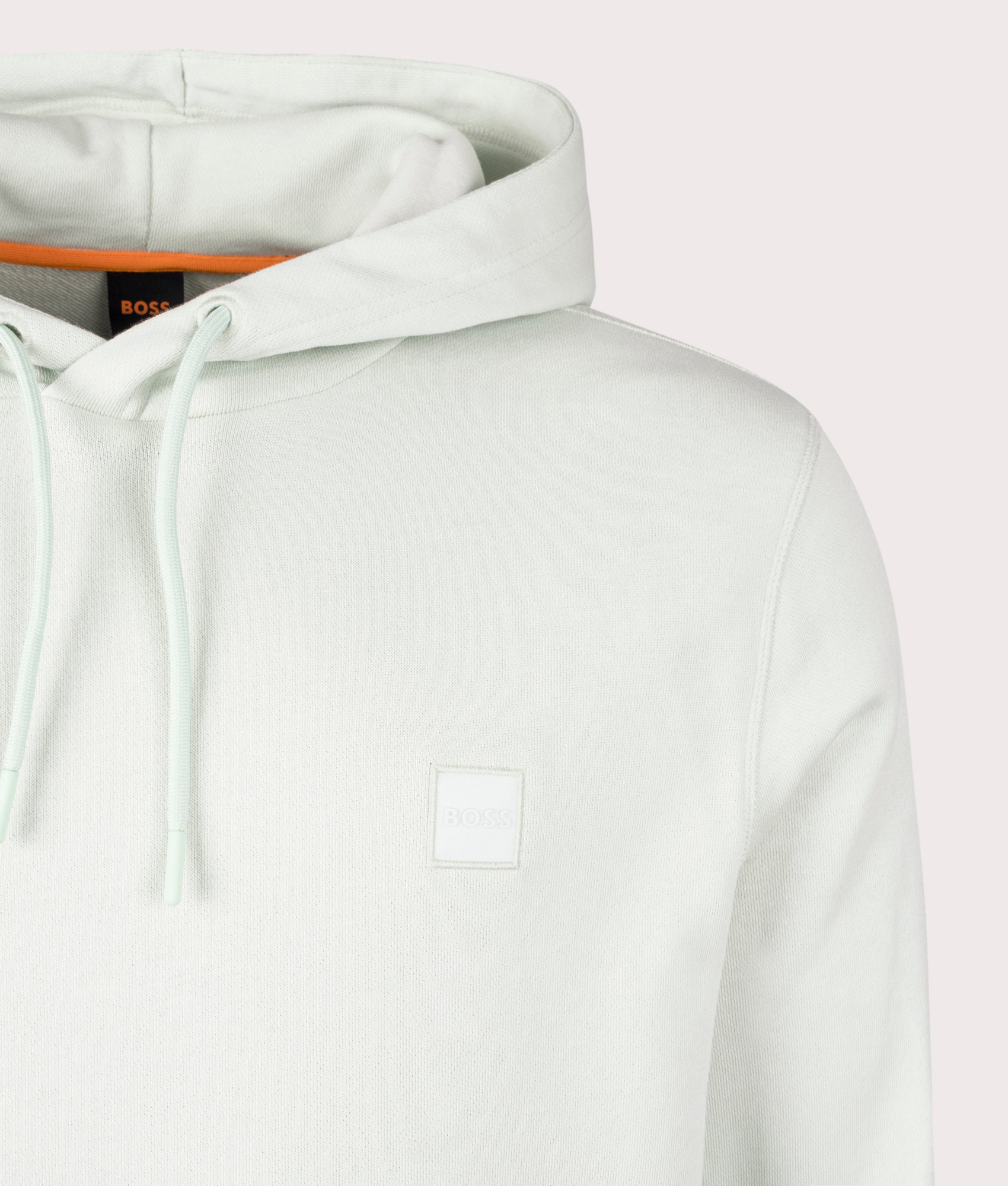 BOSS Wetalk Hoodie in Open Green . Shot at EQVVS. Front logo shot 
