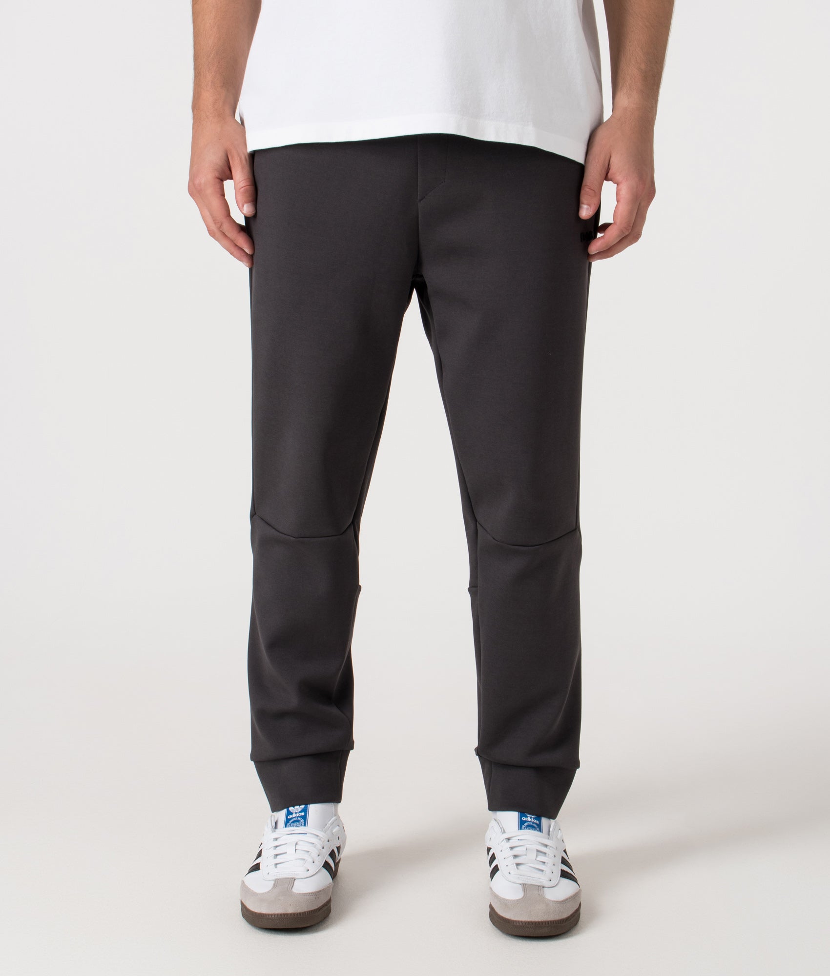 Zone Track Pants in Light/Pastel Grey. Cotton blend | BOSS | Shot at EQVVS | Front shot 