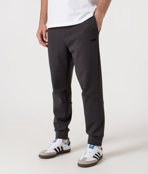 Zone Track Pants in Light/Pastel Grey. Cotton blend | BOSS | Shot at EQVVS | Front side angle 
