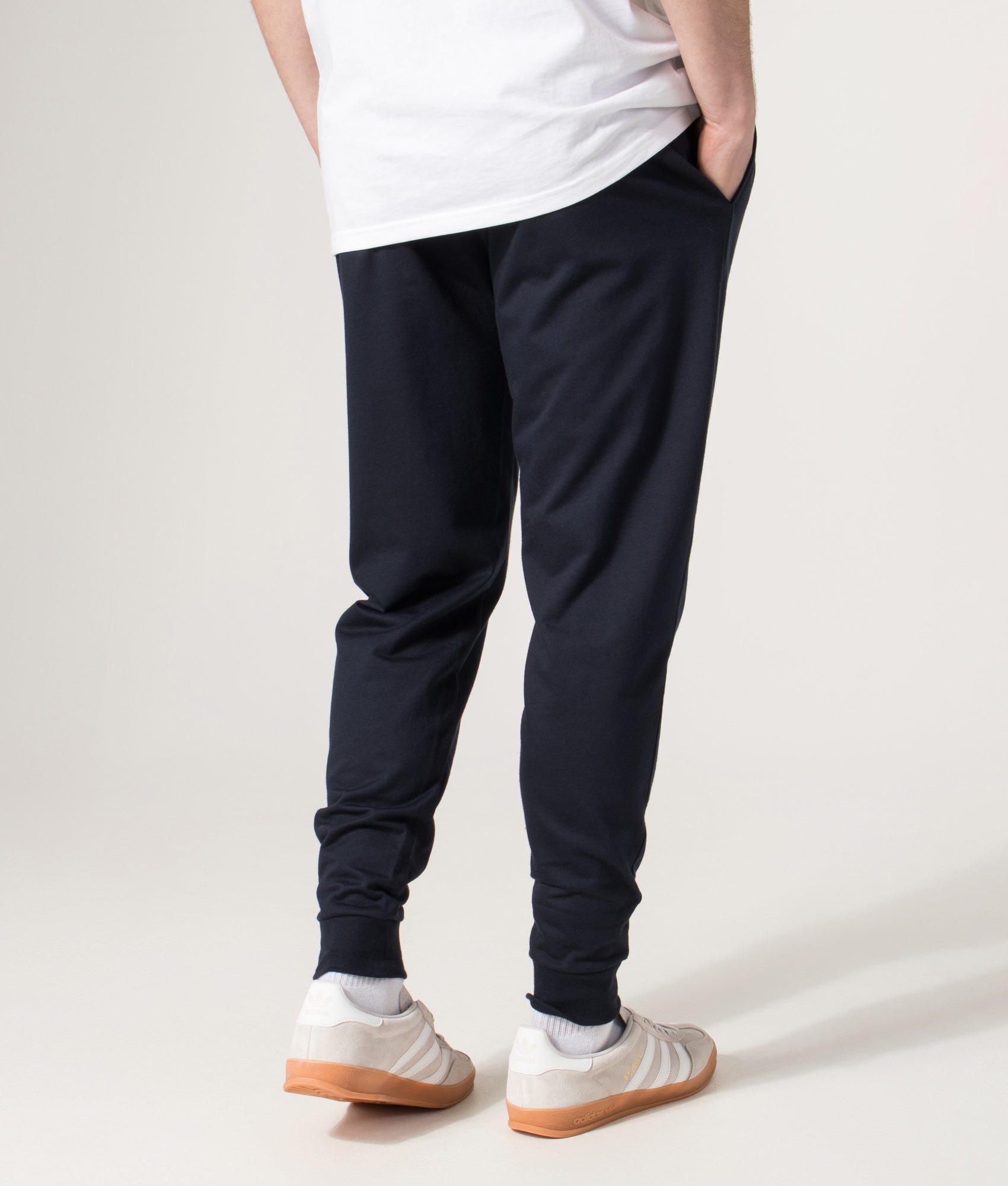 BOSS Authentic Track pants in Dark Blue at EQVVS Menswear. Angled model back shot.