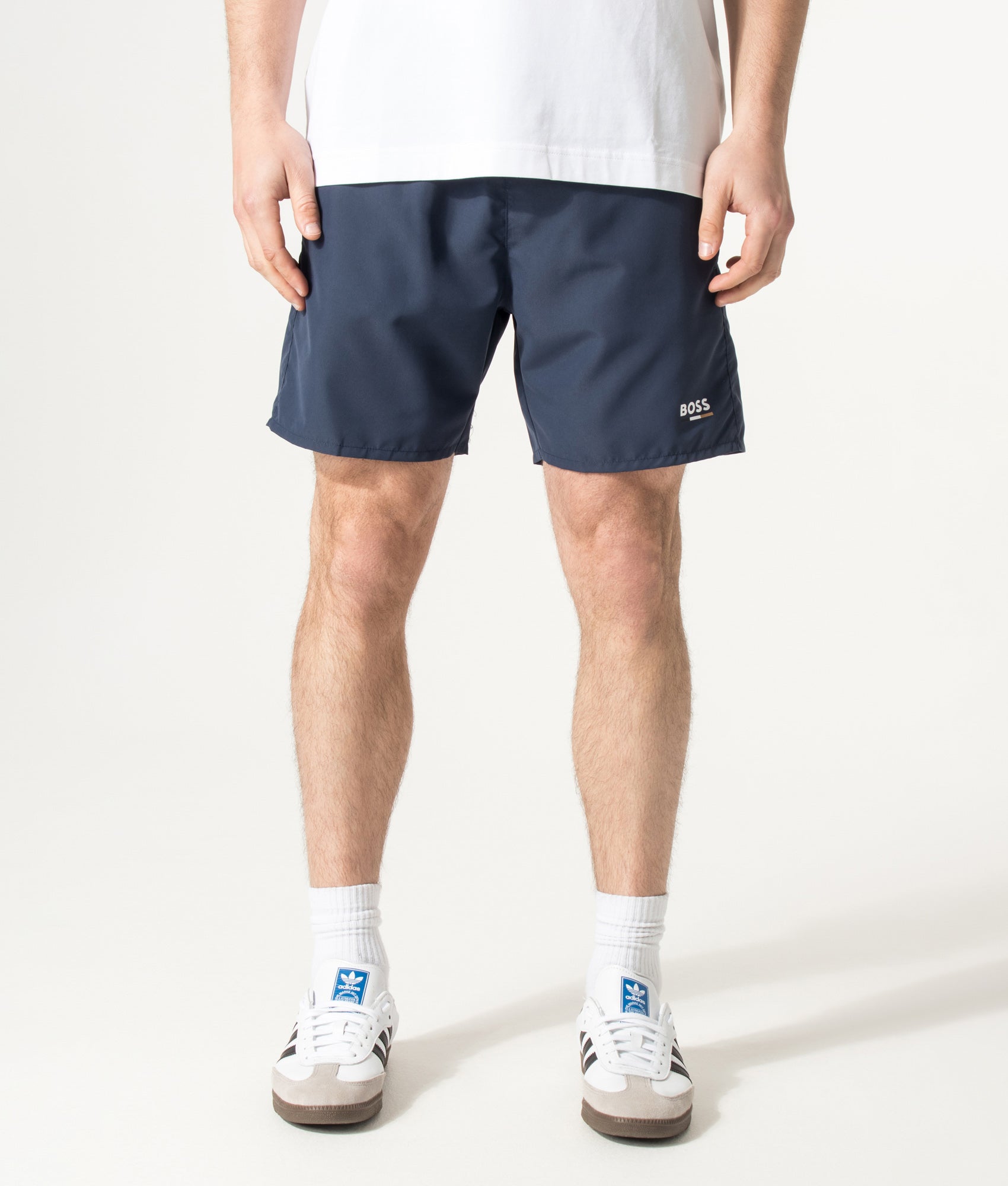 BOSS Swordfish Swim Shorts in Navy at EQVVS Menswear. Model front shot.