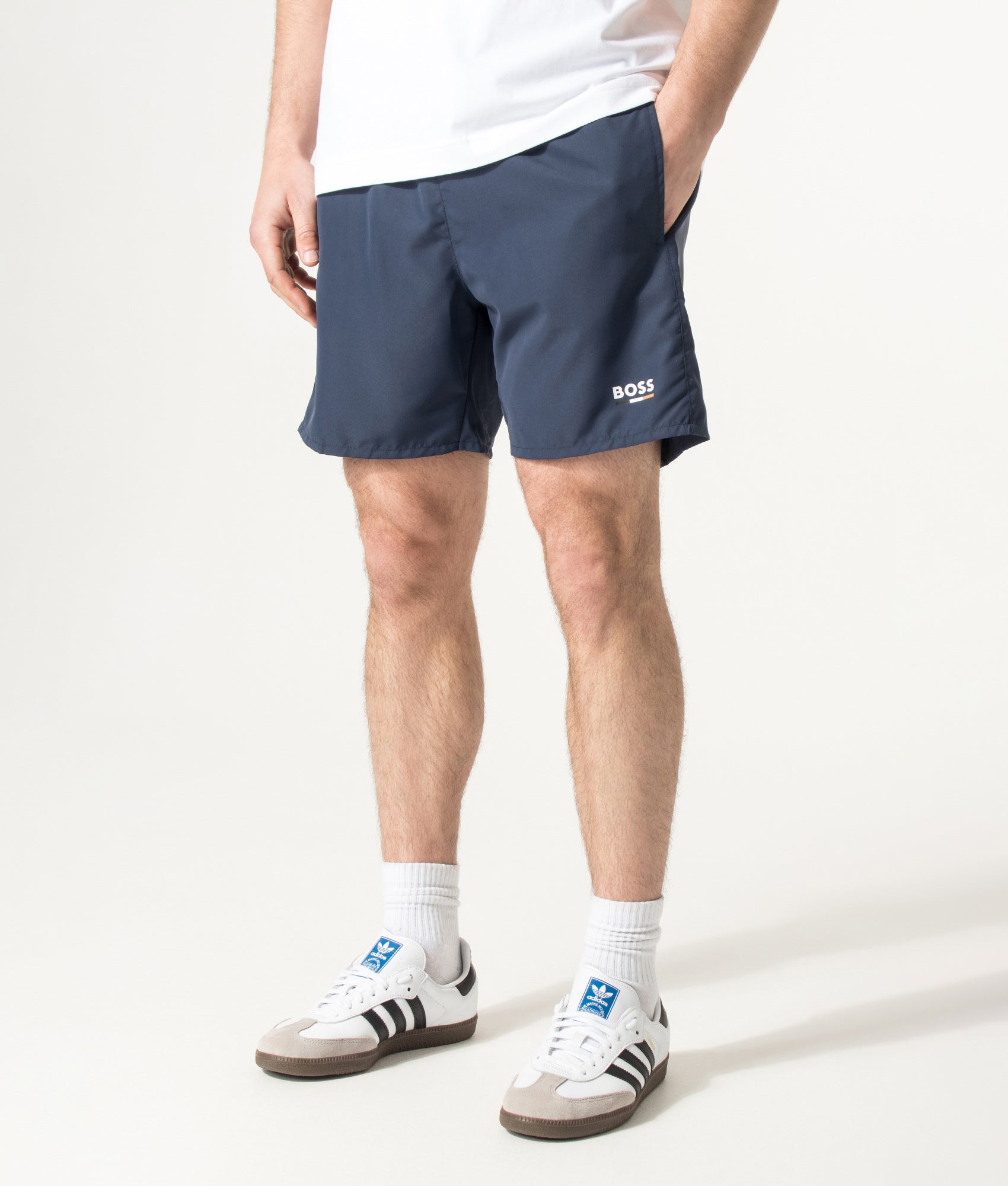 BOSS Swordfish Swim Shorts in Navy at EQVVS Menswear. Angled model front shot.
