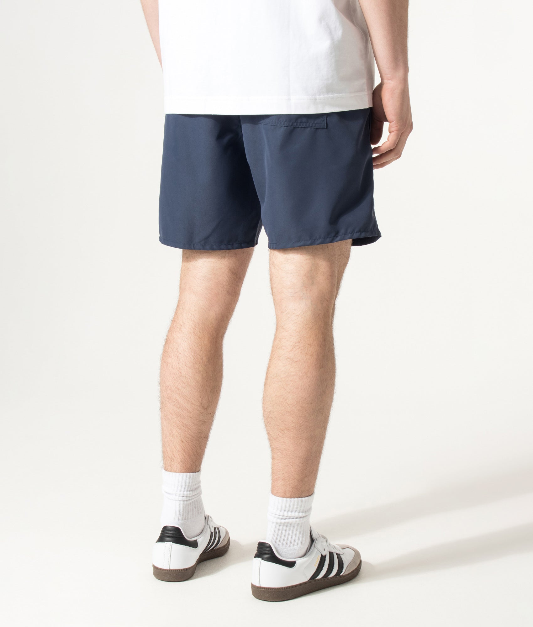 BOSS Swordfish Swim Shorts in Navy at EQVVS Menswear. Angled model back shot.