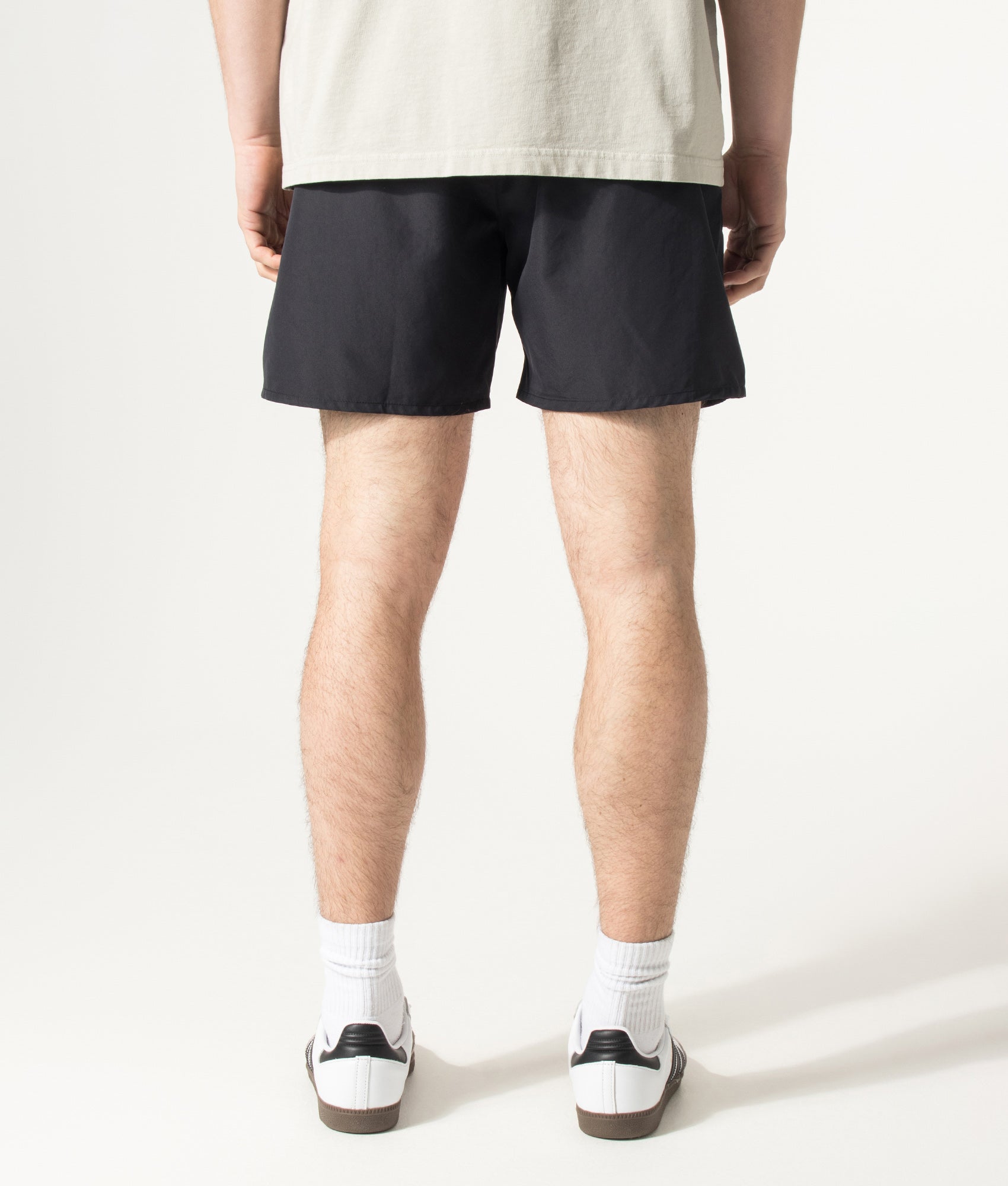 BOSS Swordfish Swim Shorts in Black at EQVVS Menswear. Model back shot.