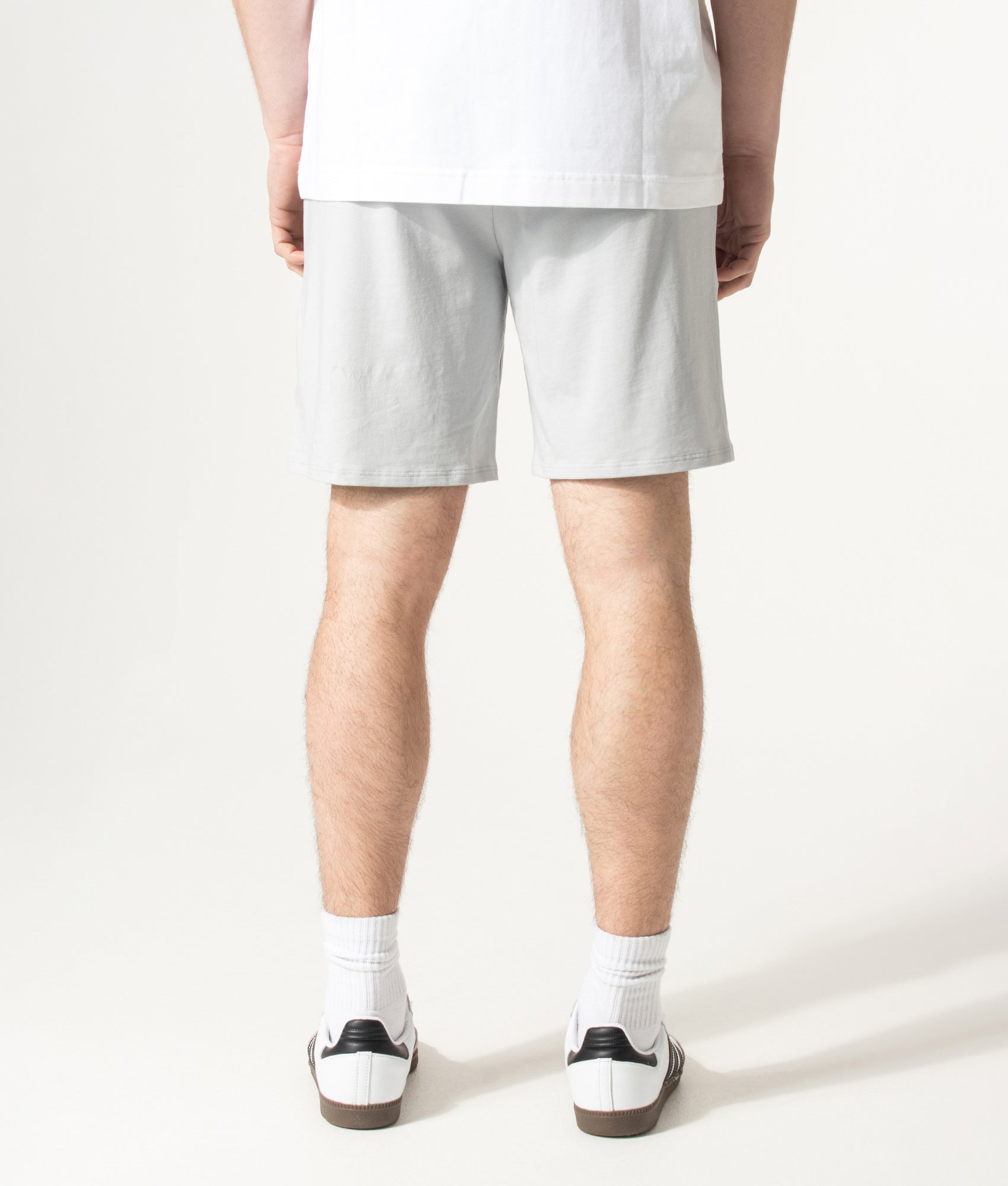 BOSS Unique Lounge Shorts in Light/Pastel Grey at EQVVS Menswear. Model back shot.