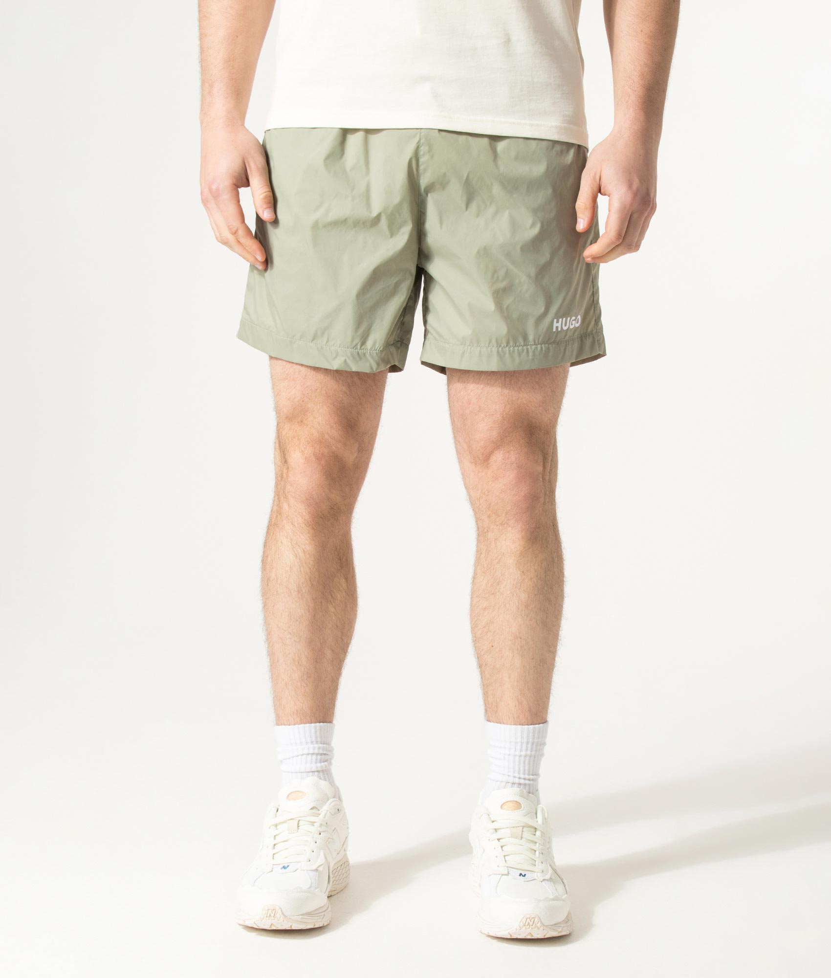 HUGO HAITI Swim Shorts in Dark Green at EQVVS Menswear. Model front shot.