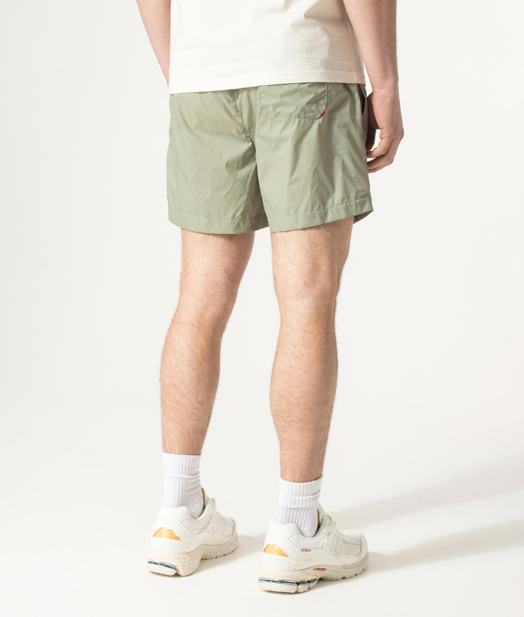 HUGO HAITI Swim Shorts in Dark Green at EQVVS Menswear. Angled model back shot.