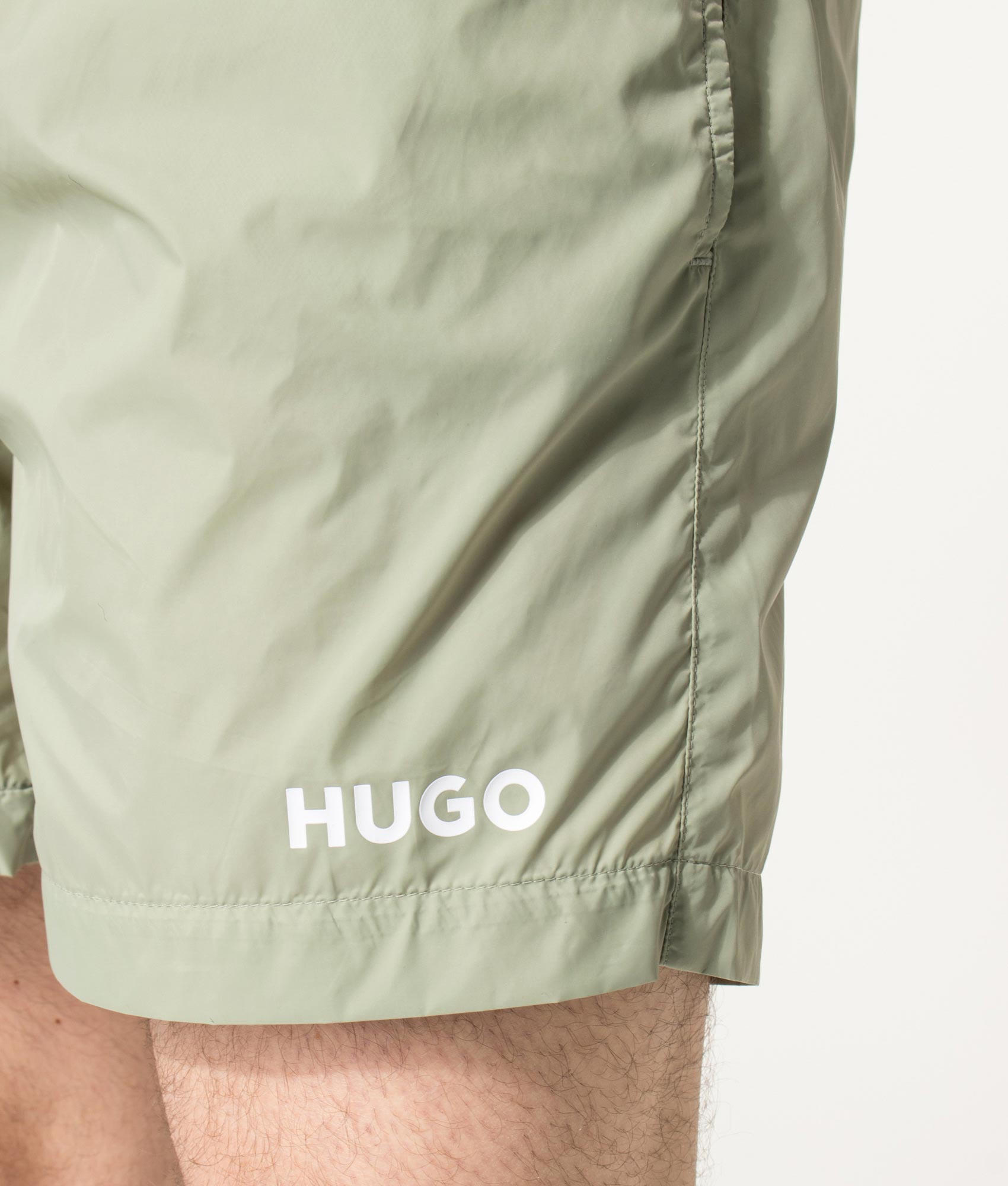 HUGO HAITI Swim Shorts in Dark Green at EQVVS Menswear. Detail shot.