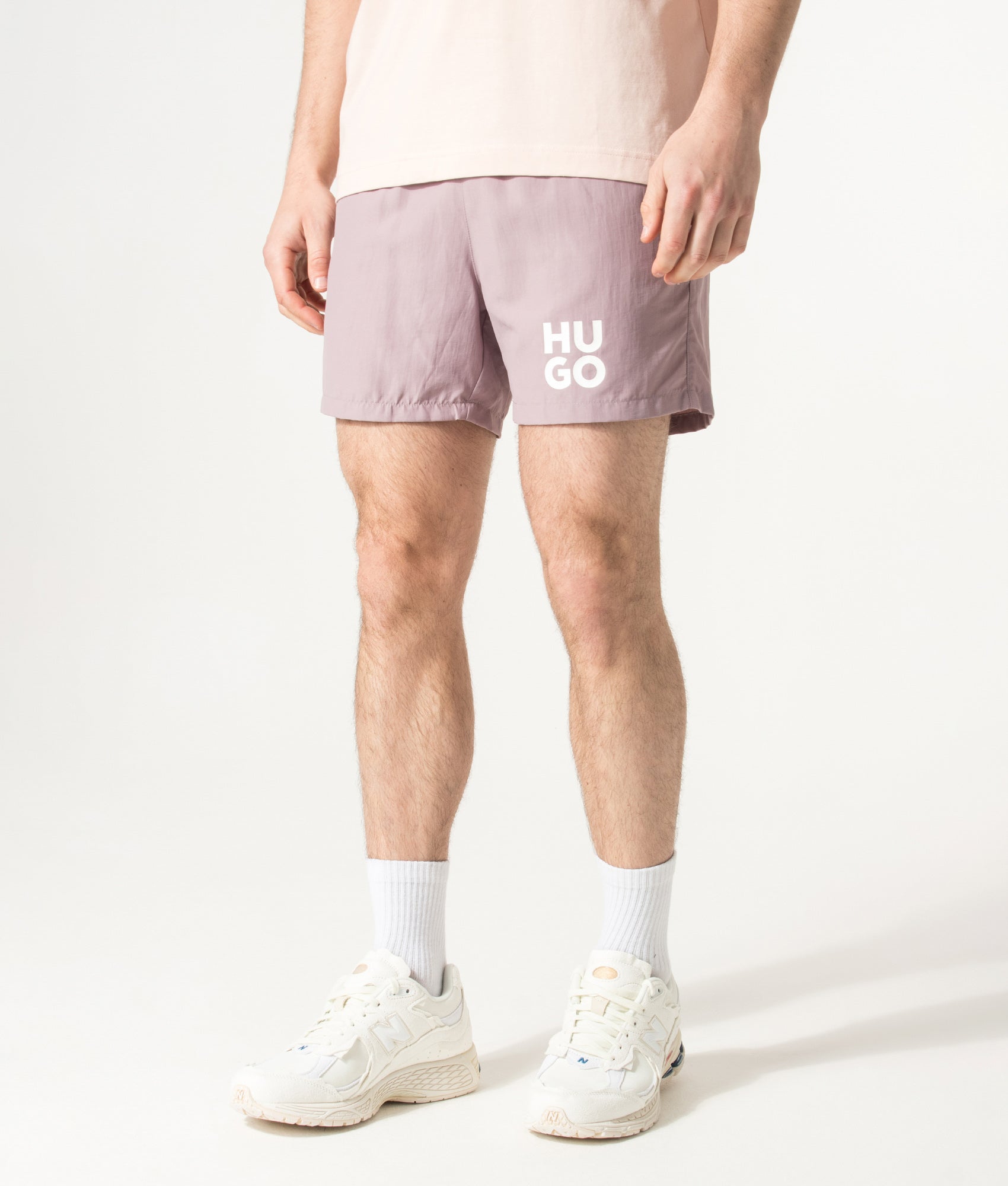 HUGO PAOLO Swim Shorts in Light/Pastel Pink at EQVVS Menswear. Angled model front shot.