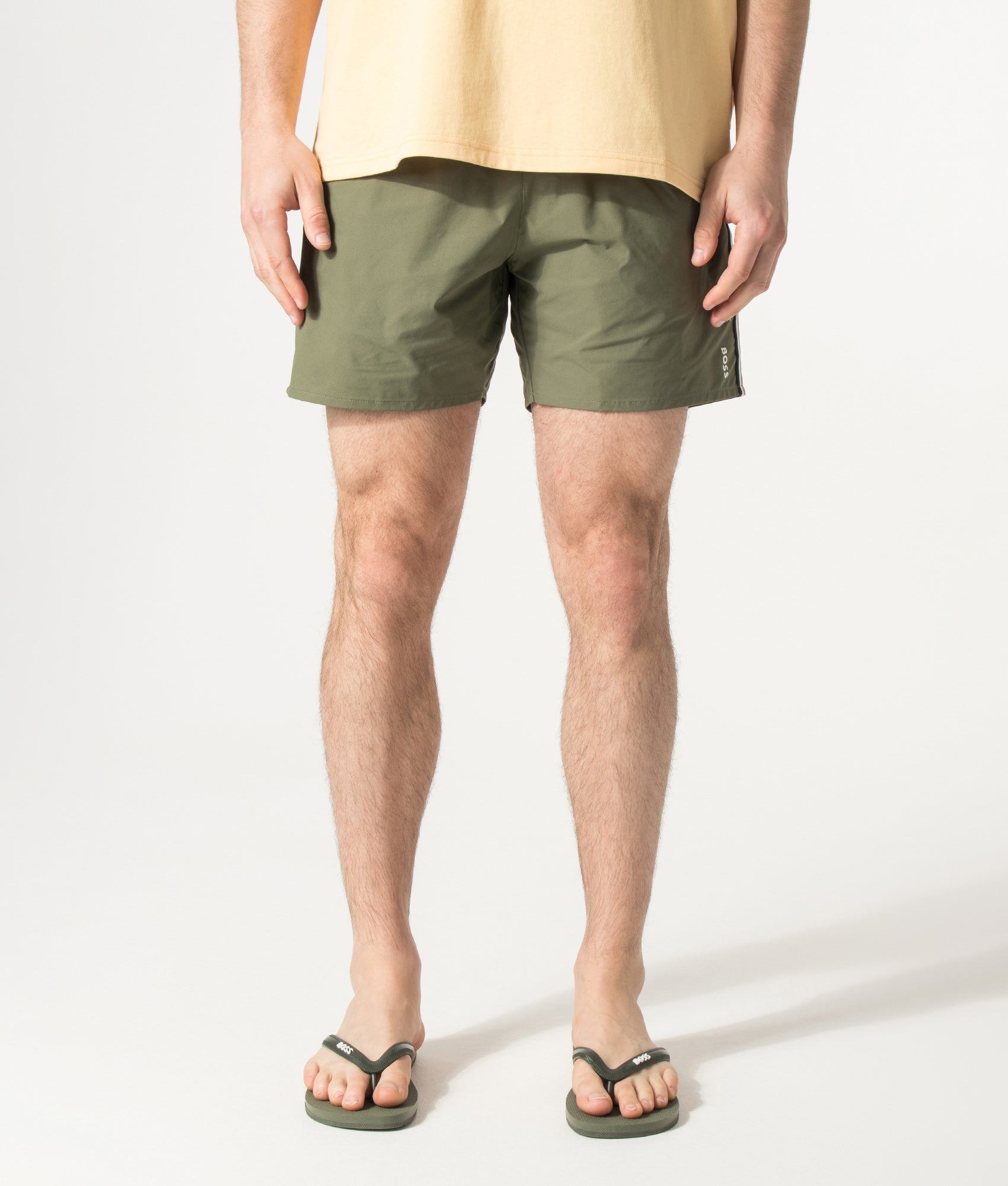 BOSS Iconic Swim Shorts in Open Green at EQVVS Menswear. Model front shot.