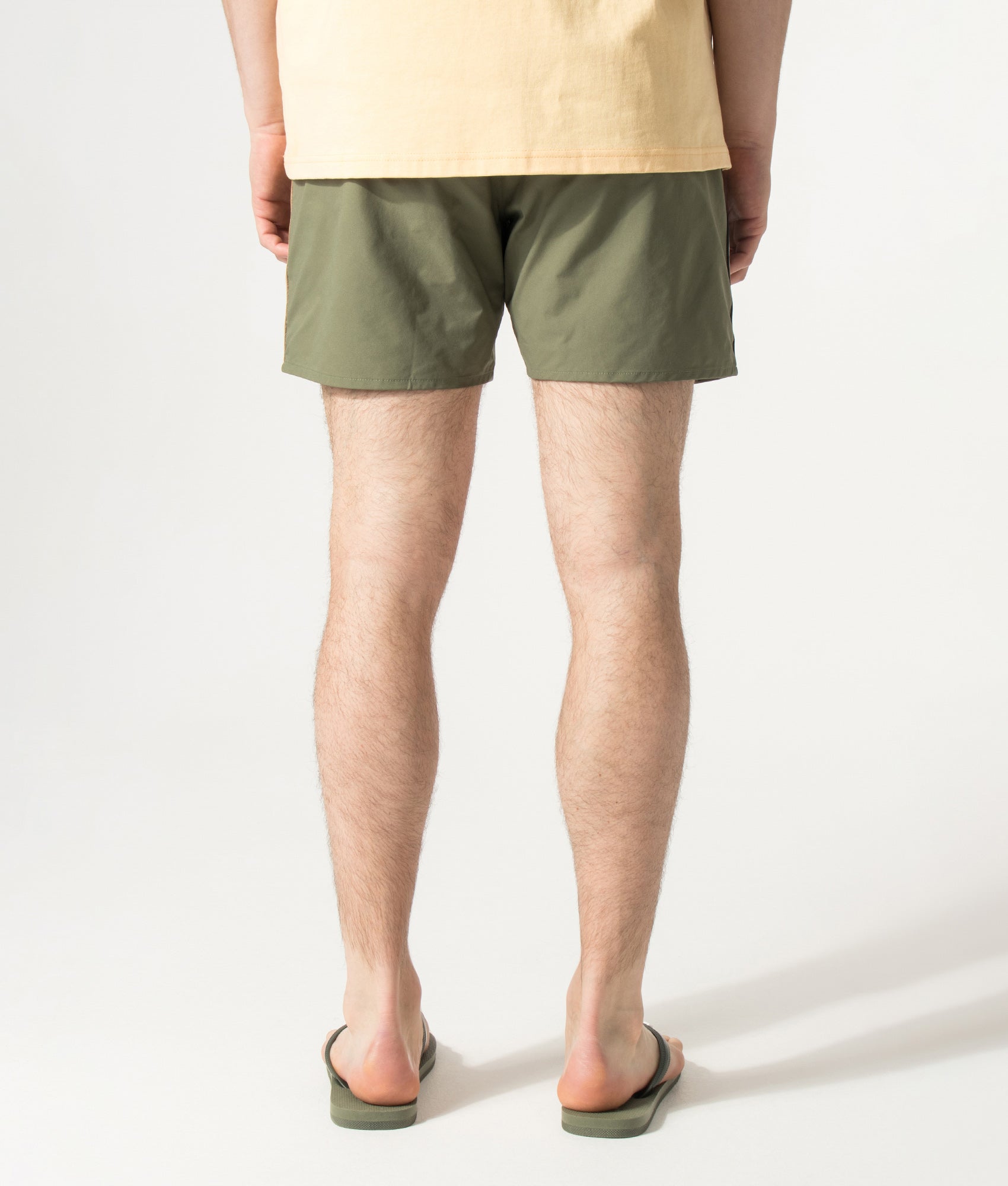 BOSS Iconic Swim Shorts in Open Green at EQVVS Menswear. Anled model back shot.