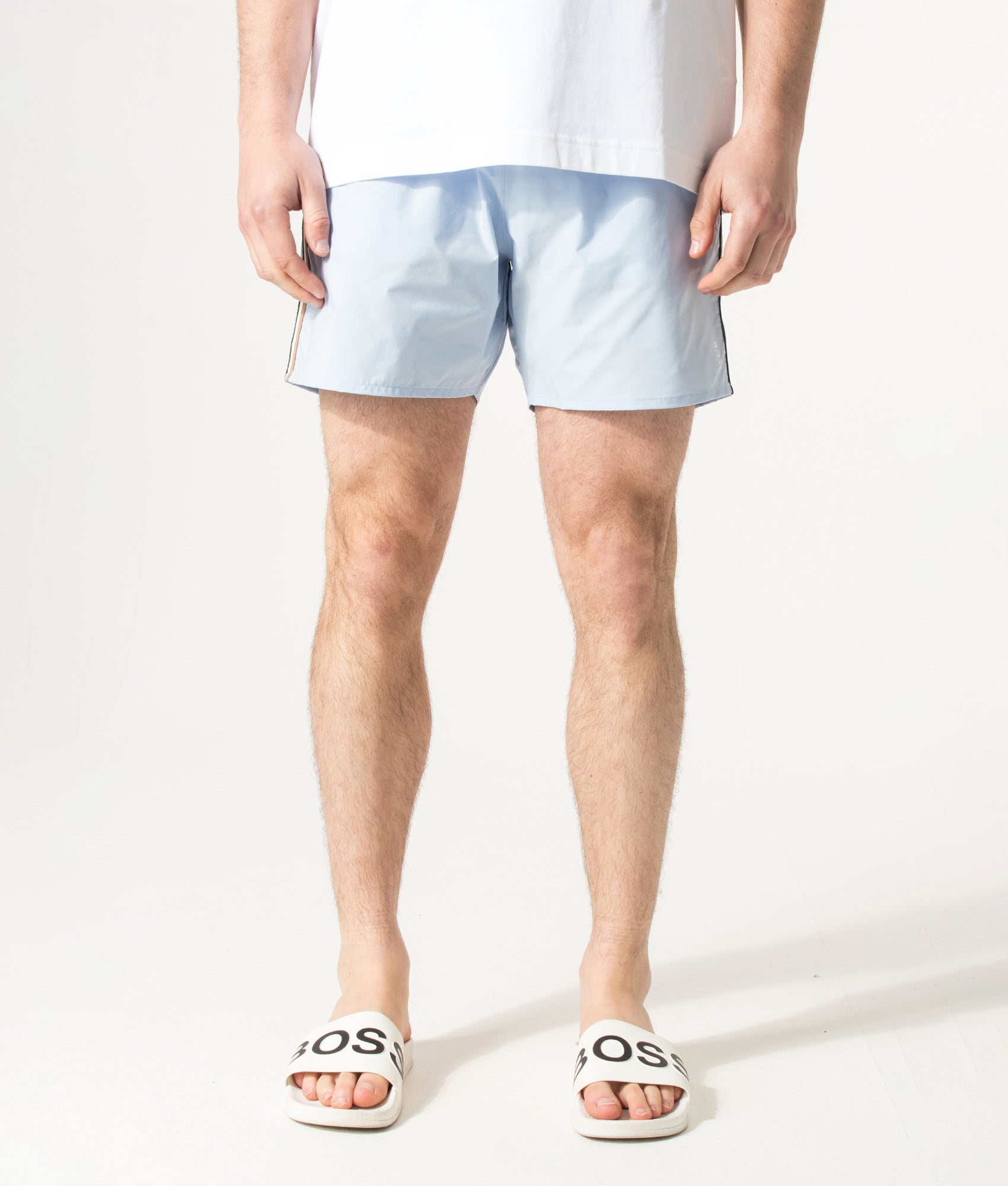 BOSS Iconic Swim Shorts in Light/Pastel Blue at EQVVS Menswear. Model front shot.