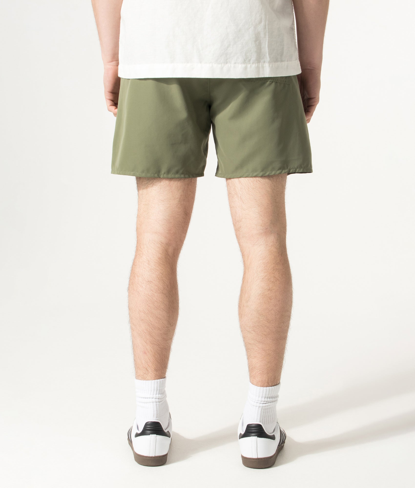 BOSS Swordfish Swim Shorts in Open Green at EQVVS Menswear. Model back shot.