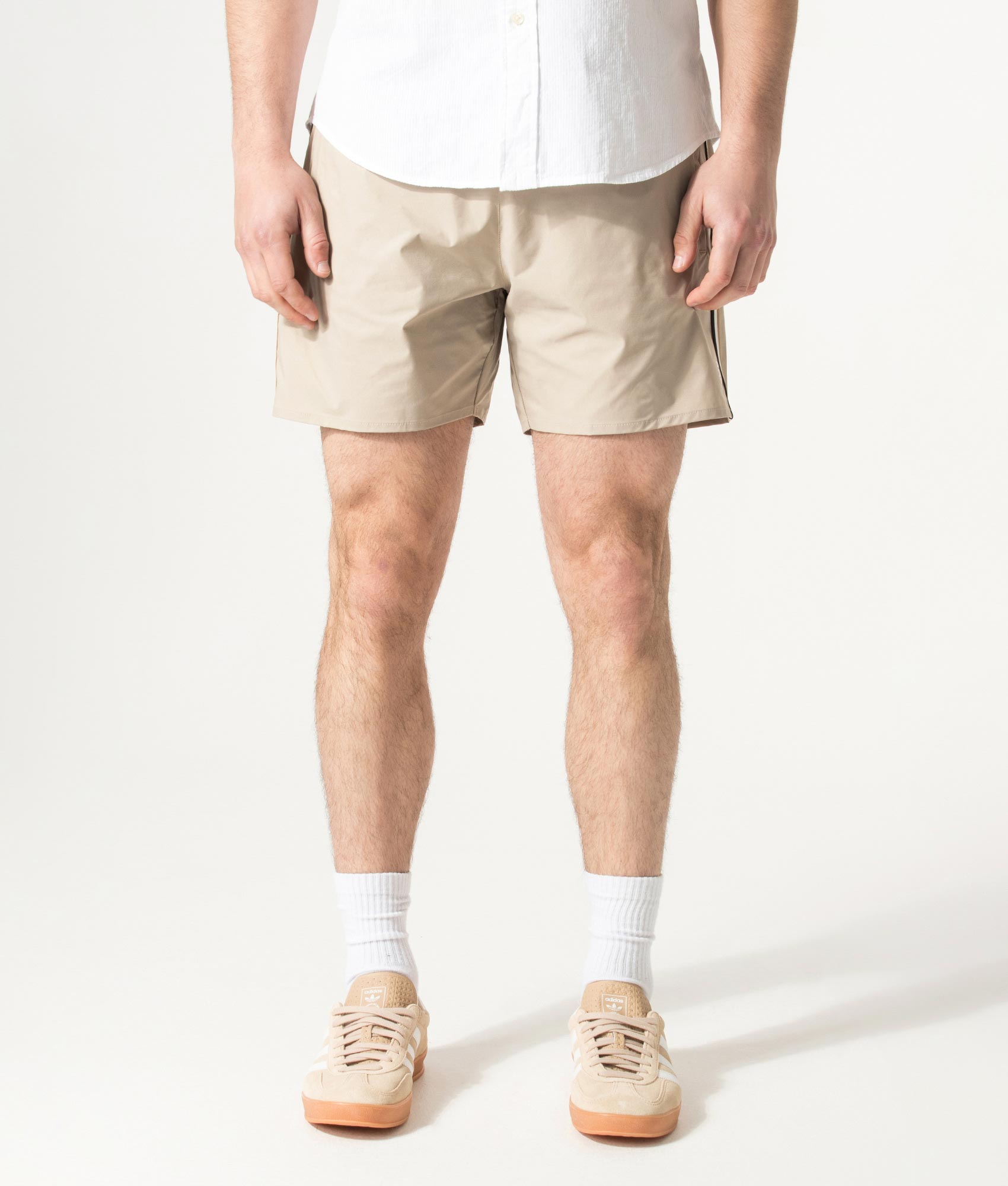 BOSS Iconic Swim Shorts in Light Beige at EQVVS Menswear. Model front shot.