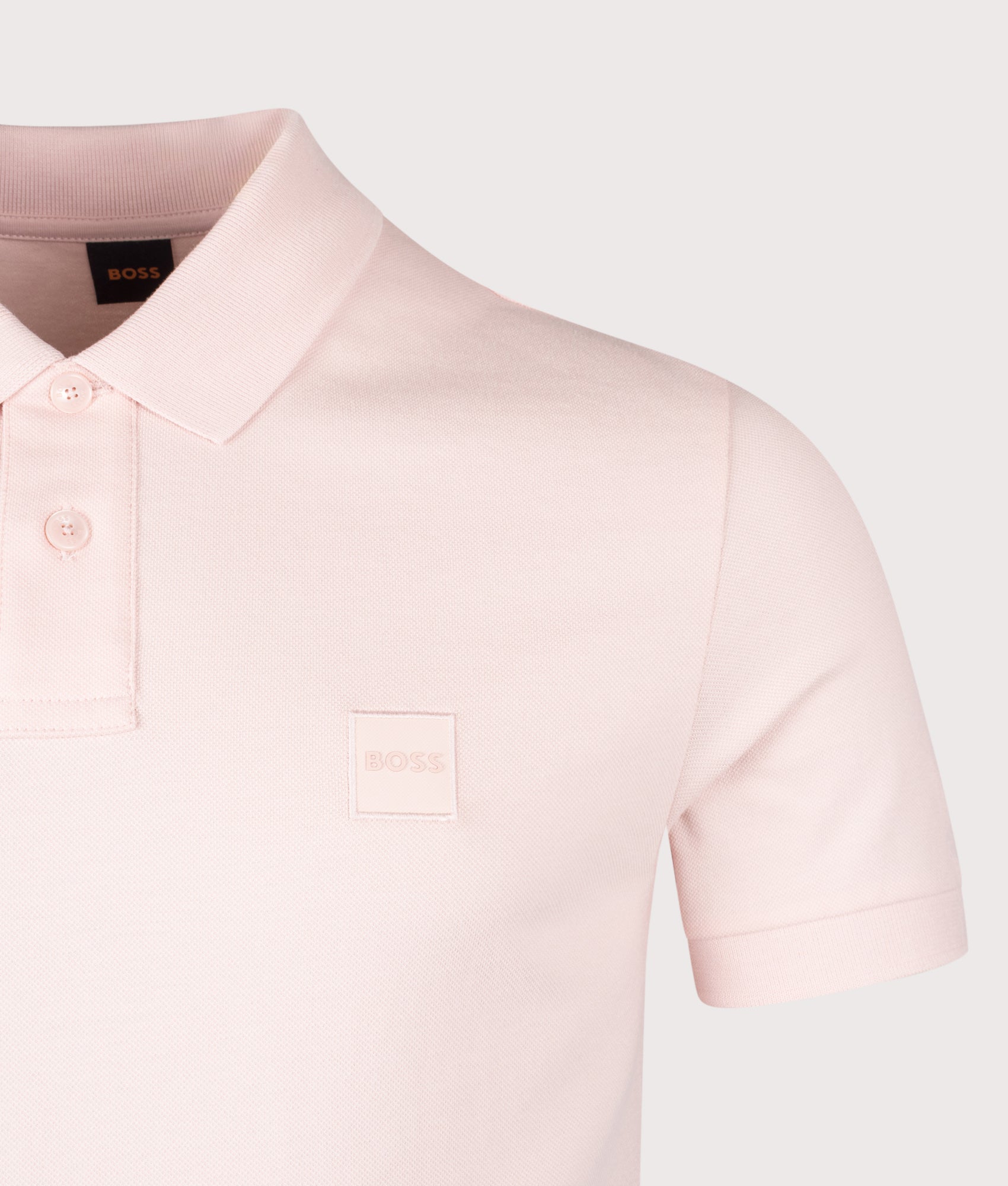 BOSS Slim Fit Passenger Polo Shirt in Open Pink at EQVVS Menswear. Detail shot.