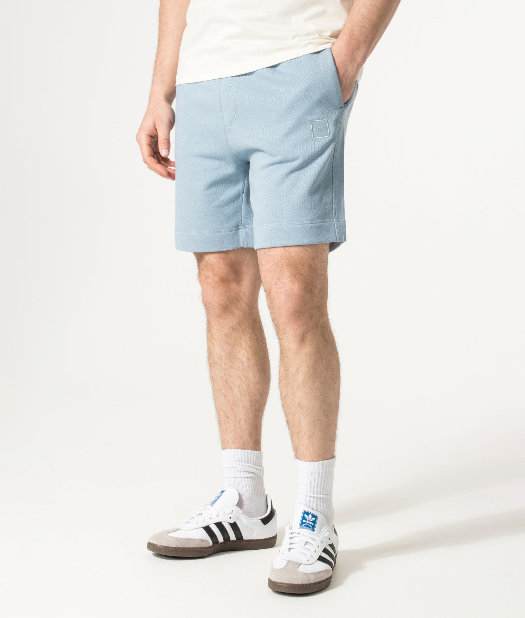BOSS Sewalk Sweat Shorts in Light/Pastel Blue at EQVVS Menswear. Angled model front shot.