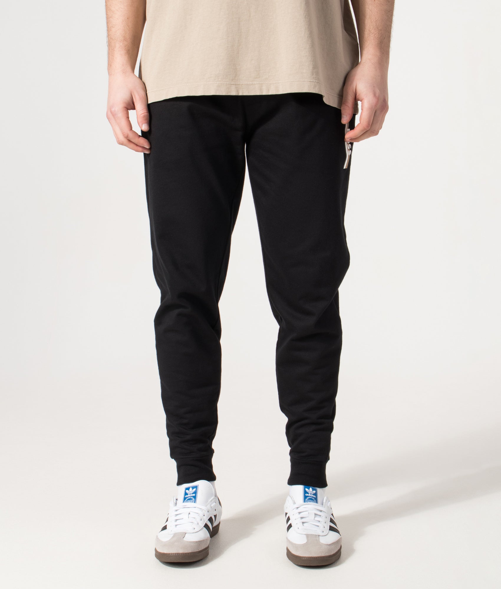 BOSS Authentic Track pants in Black at EQVVS Menswear. Model front shot.