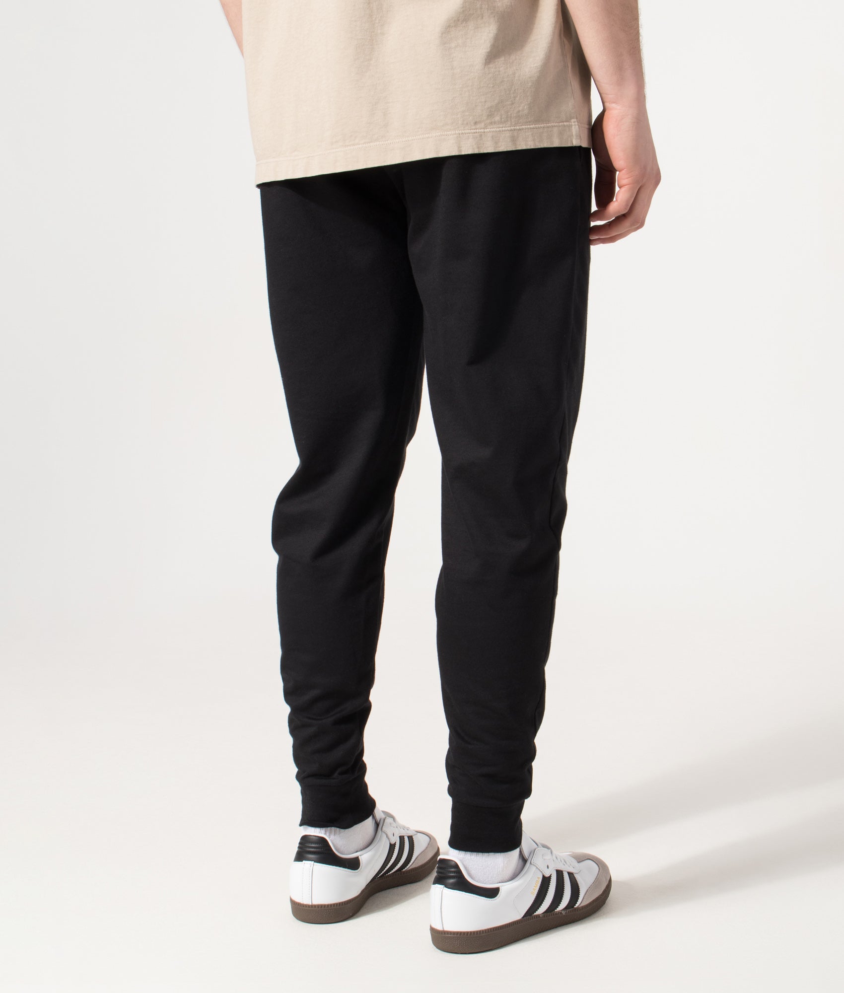 BOSS Authentic Track pants in Black at EQVVS Menswear. Angled model back shot.