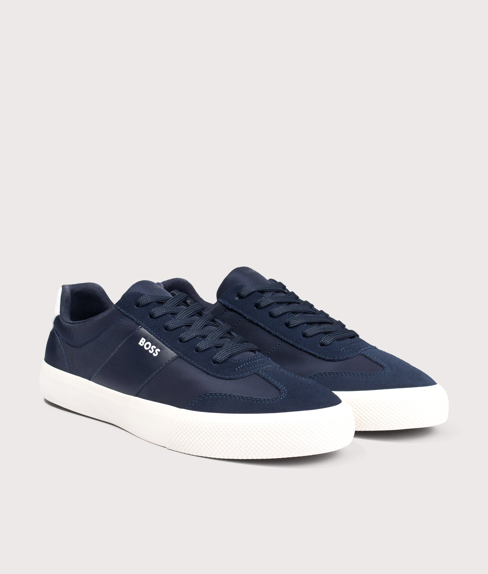 BOSS Aiden Tenn Trainers in Dark Blue at EQVVS Menswear. Angled front shot.