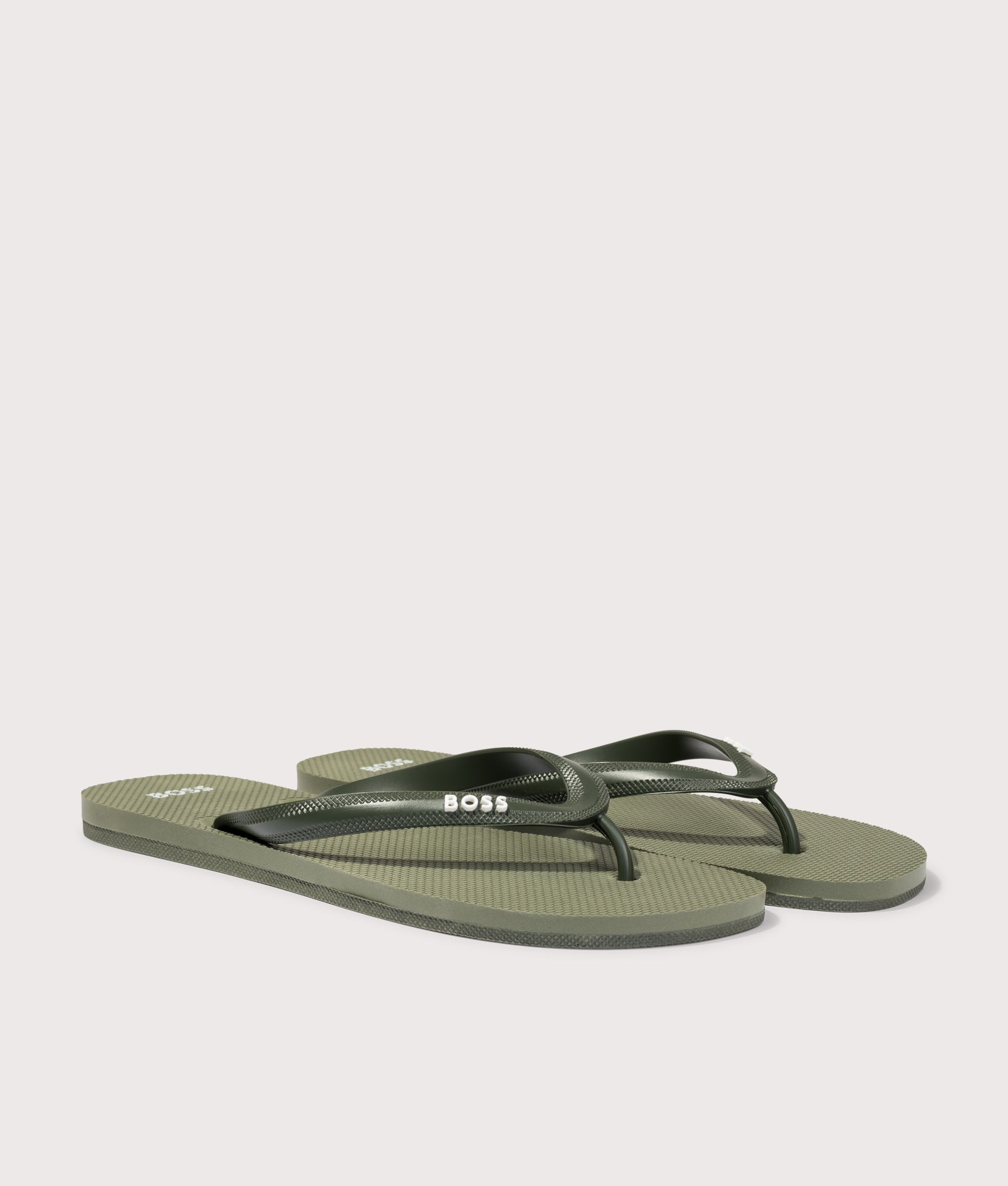 BOSS Tracy Branded Strap Flip Flops in Open Green at EQVVS Menswear. Angled front shot.