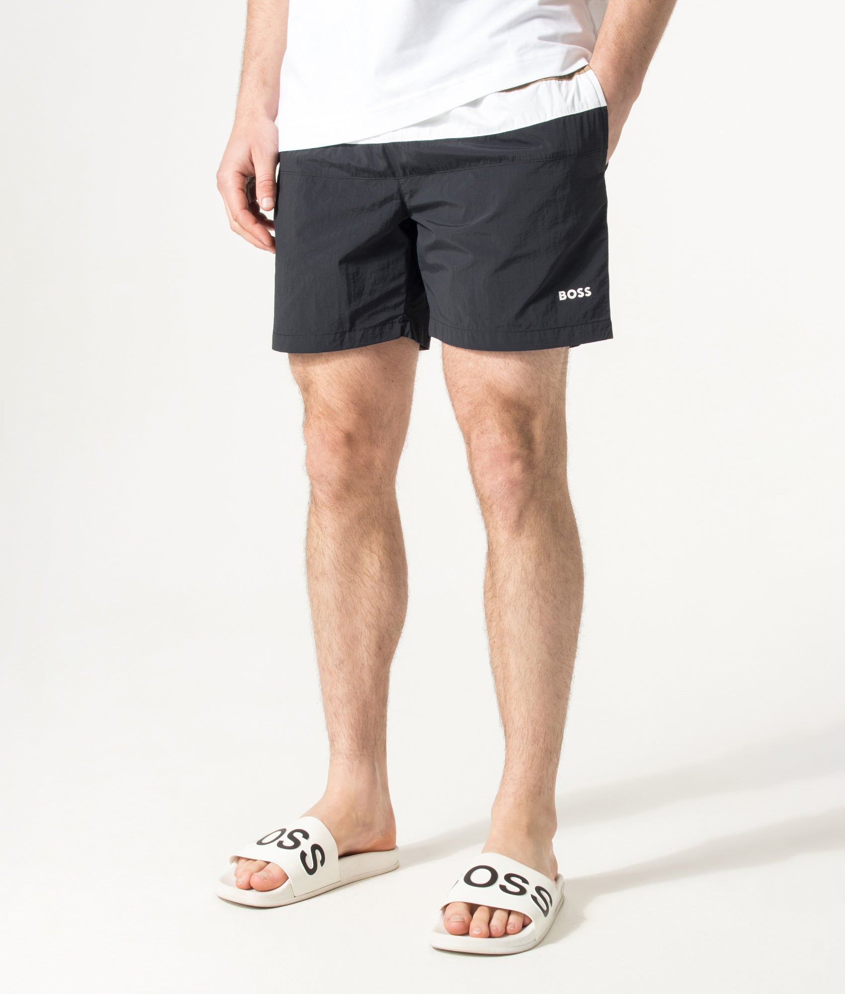 BOSS Louis Swim Shorts in Black at EQVVS Menswear. Angled model front shot.