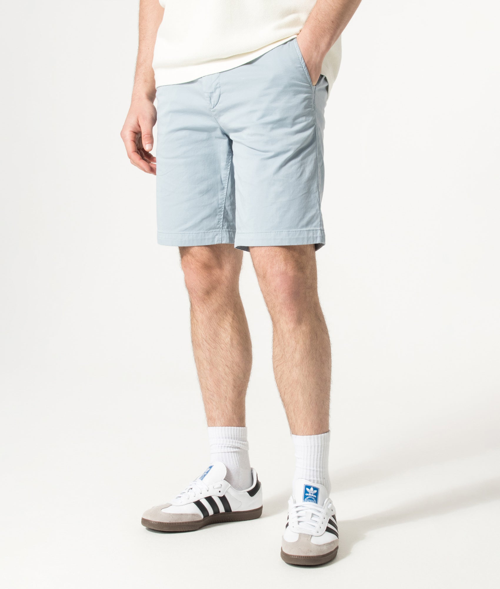 BOSS Slim Fit Chino Shorts in Light/Pastel Blue at EQVVS Menswear. Angled model front shot.