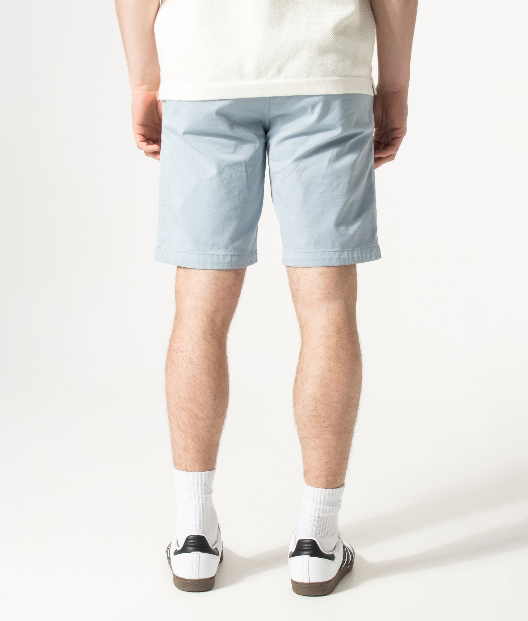 BOSS Slim Fit Chino Shorts in Light/Pastel Blue at EQVVS Menswear. Model back shot.