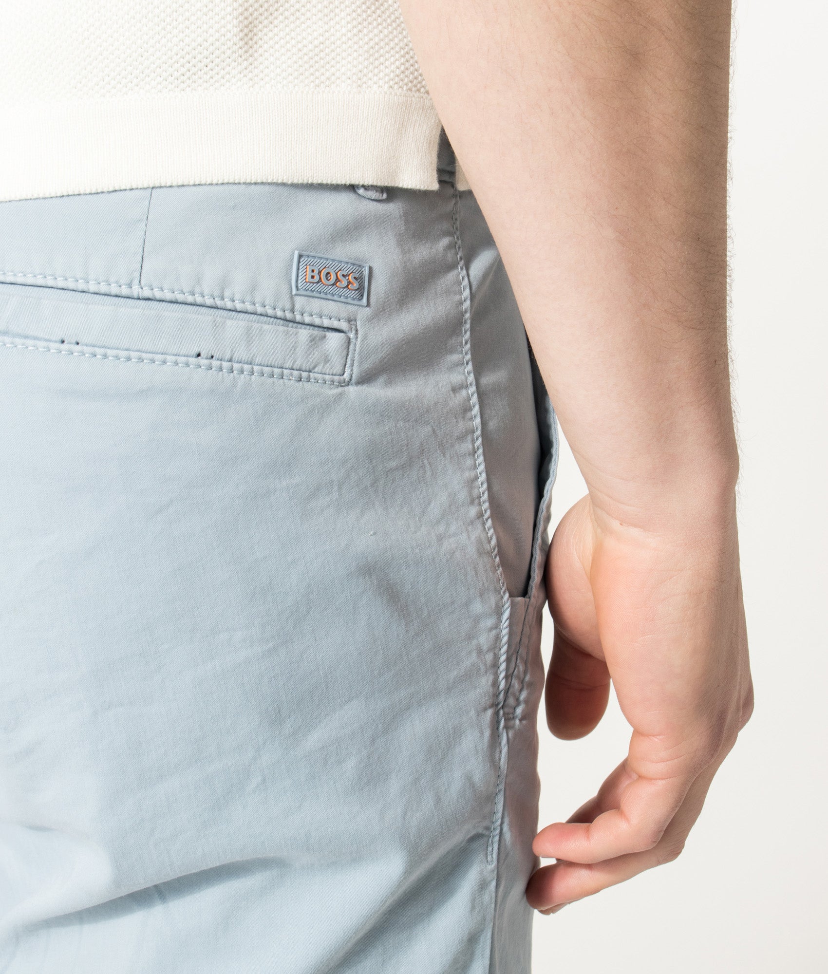 BOSS Slim Fit Chino Shorts in Light/Pastel Blue at EQVVS Menswear. Detail shot.