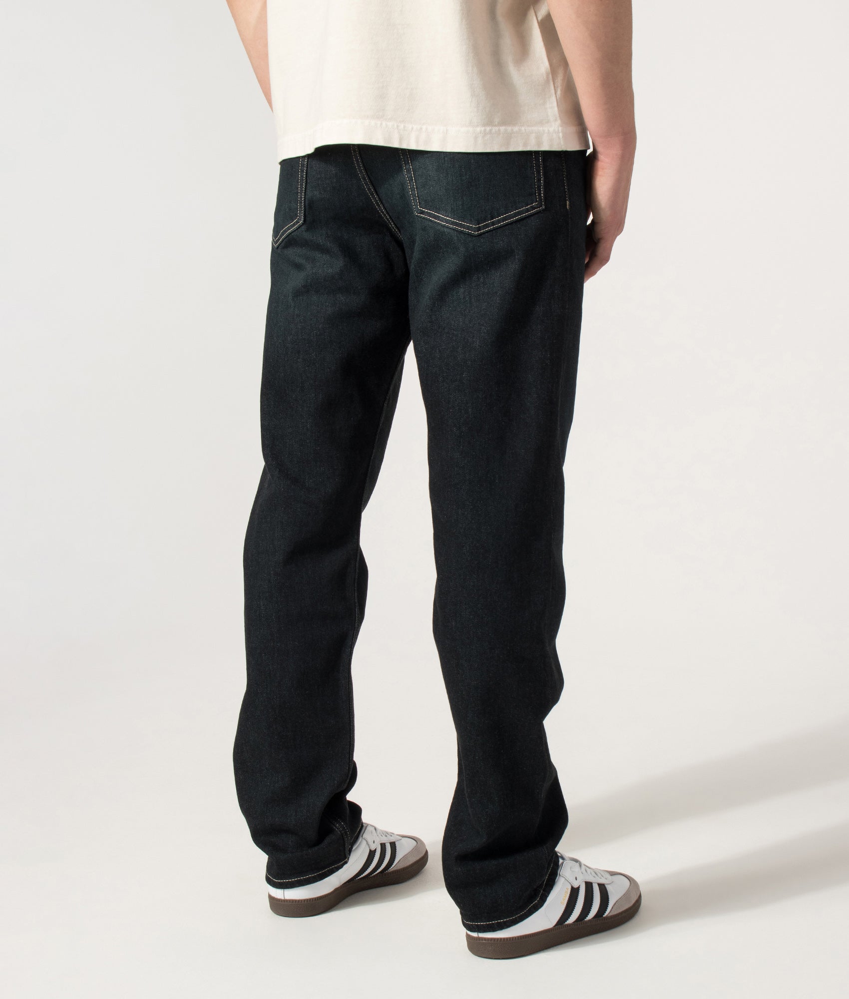 BOSS Ogden 3 Straight Leg Jeans in Dark Blue at EQVVS Menswear. Angled model back shot.