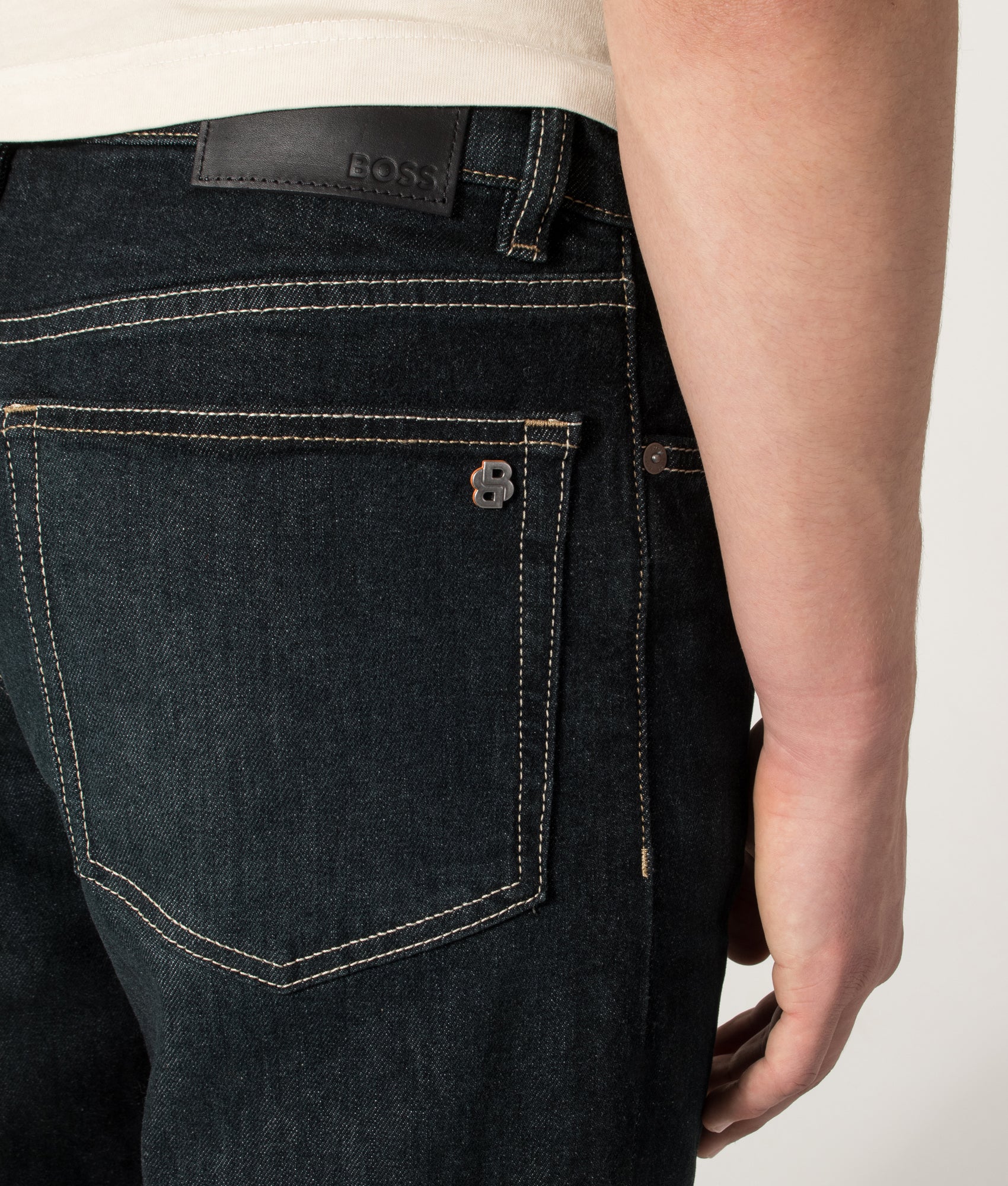 BOSS Ogden 3 Straight Leg Jeans in Dark Blue at EQVVS Menswear. Detail shot.