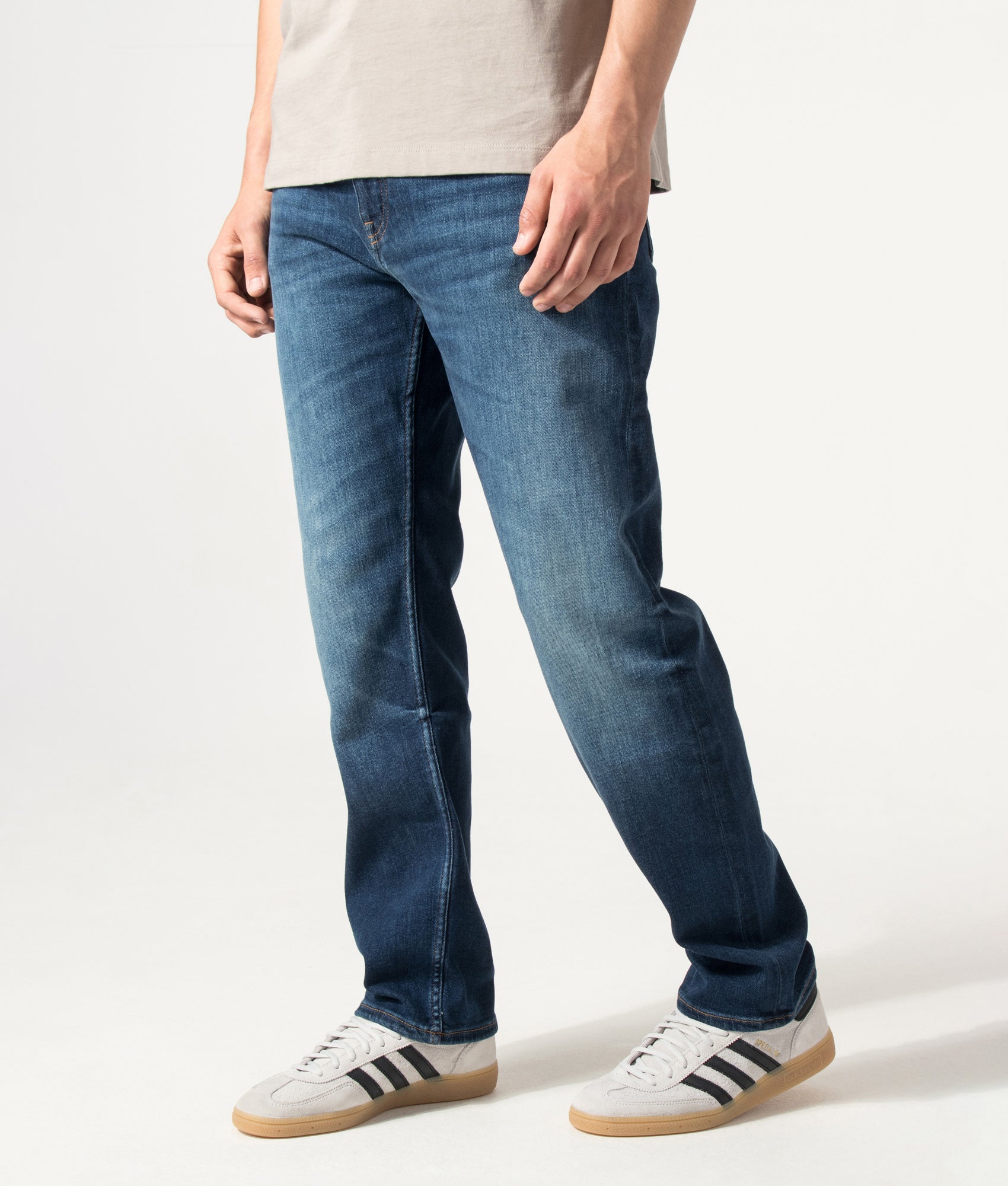 BOSS Ogden Straight Leg Jeans in Navy at EQVVS Menswear. Angled model front shot.