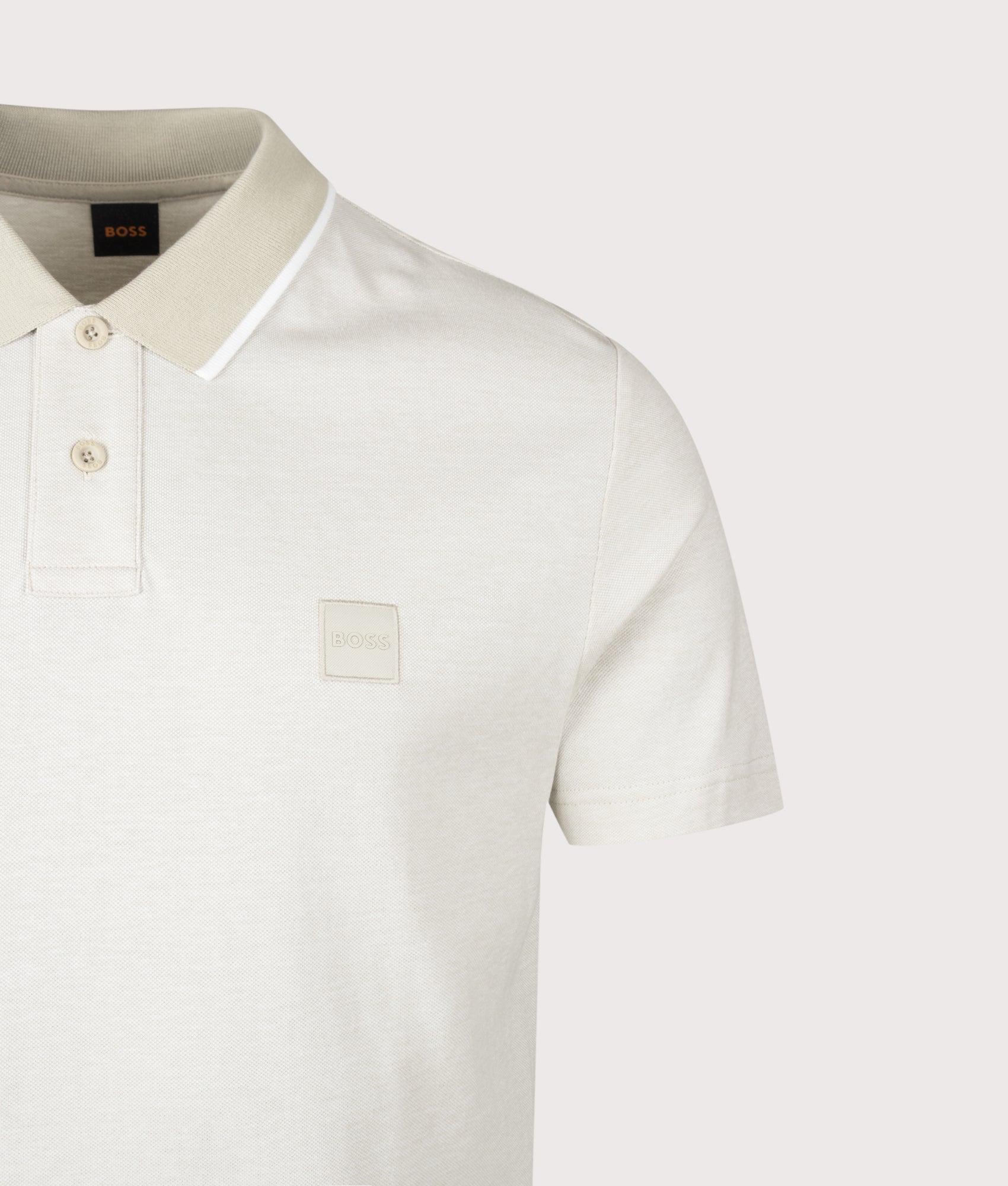 BOSS Passerford Polo Shirt in Light Beige at EQVVS Menswear. Detail shot.
