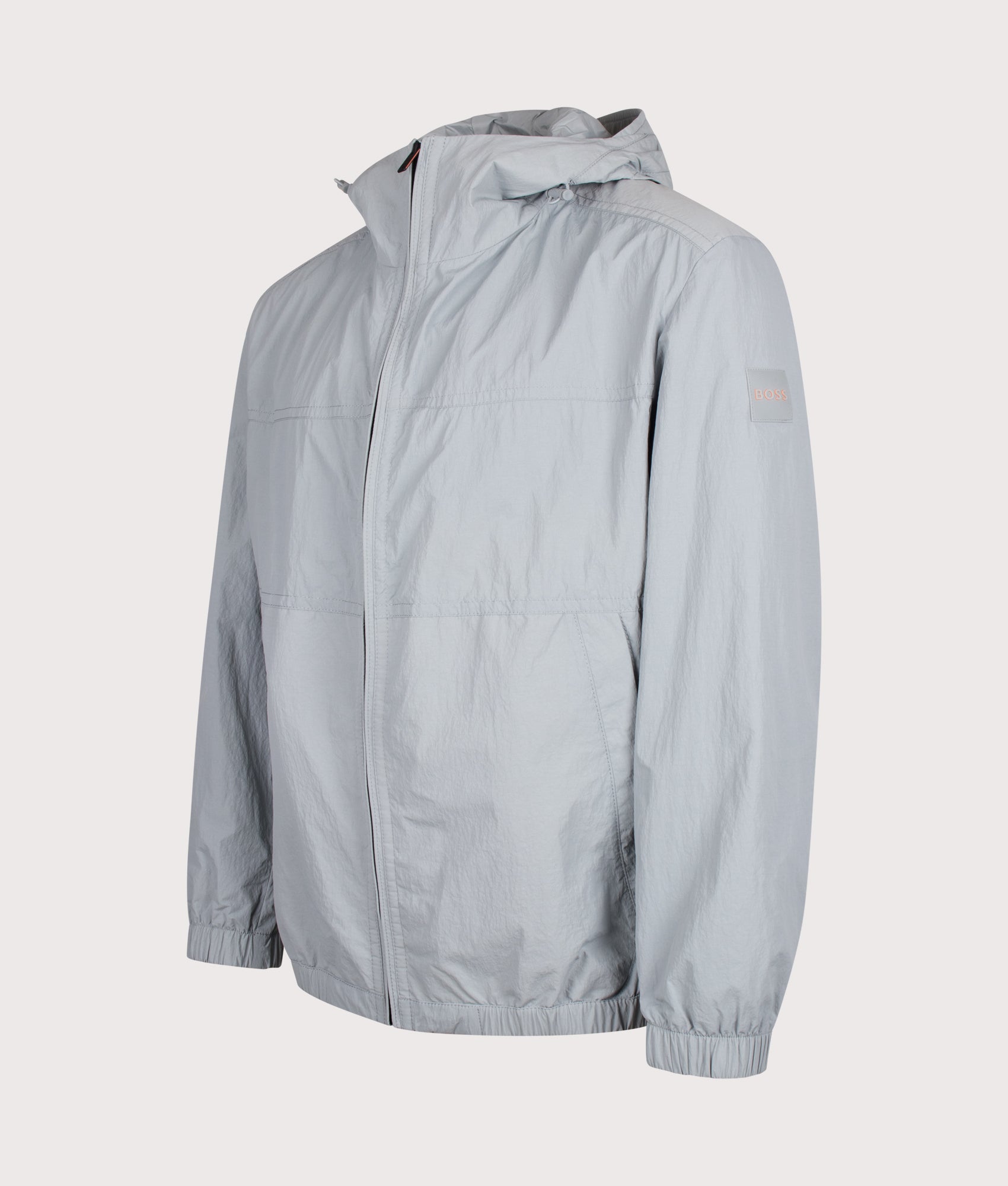 BOSS Relaxed Fit Otily1 Windbreaker Jacket in Open Grey at EQVVS Menswear. Angled front shot.
