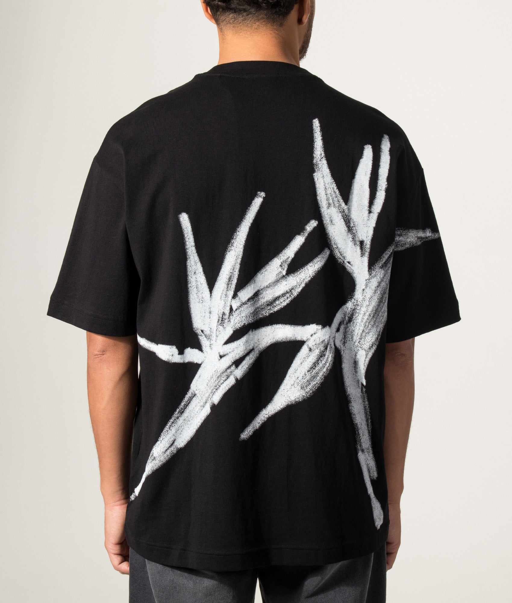 HUGO Oversized Dariso T-Shirt in Black  at EQVVS Menswear. Model back shot.