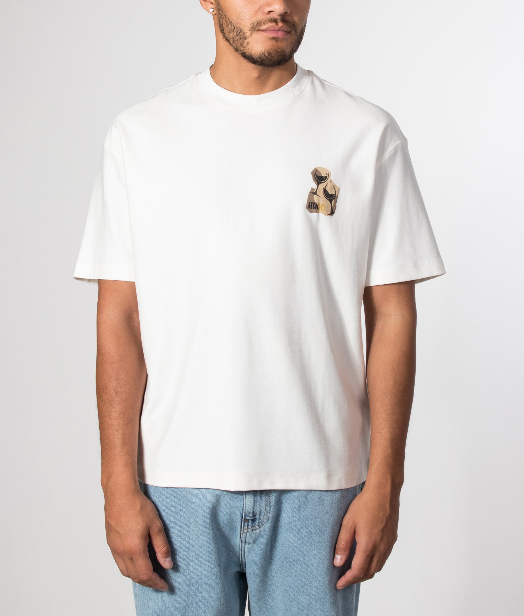 HUGO Relaxed Fit Detzi T-Shirt in Natural at EQVVS Menswear. Model front shot.