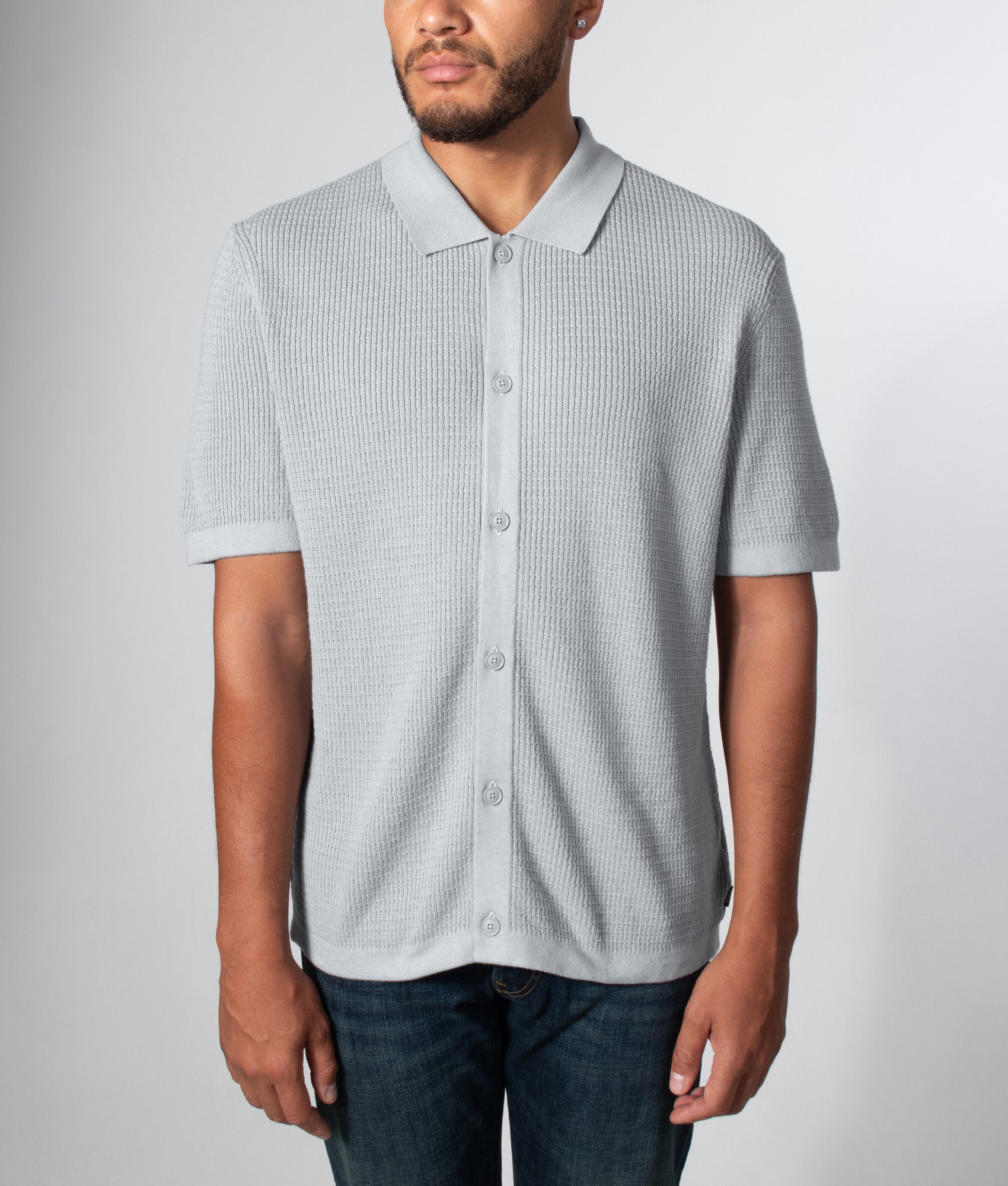 BOSS Relaxed Fit Akepalo Knitted Polo Shirt in Open Grey at EQVVS Menswear. Model front shot.