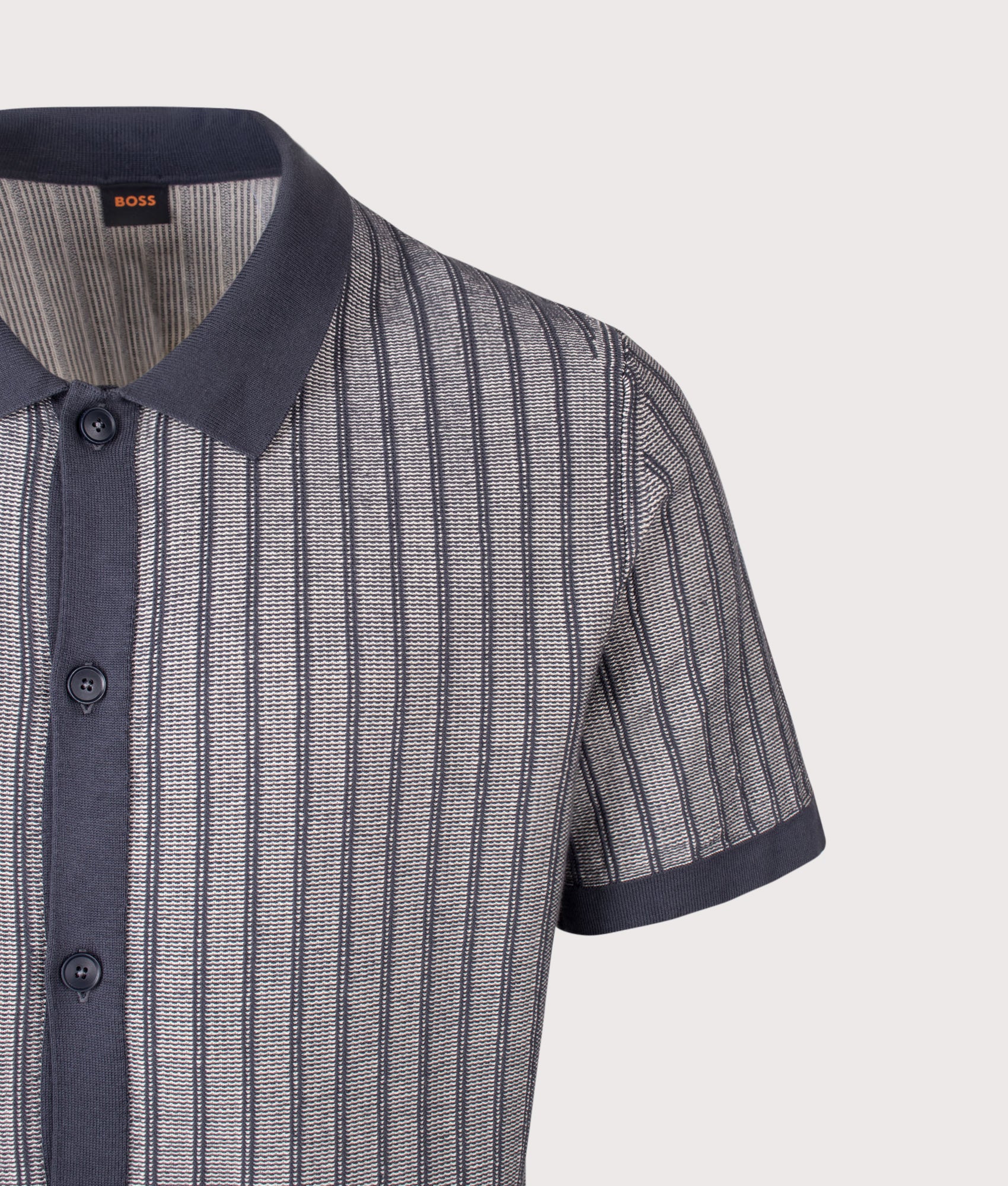 BOSS Relaxed Fit Kodd Knitted Polo Shirt in Dark Blue at EQVVS Menswear. Detail shot.