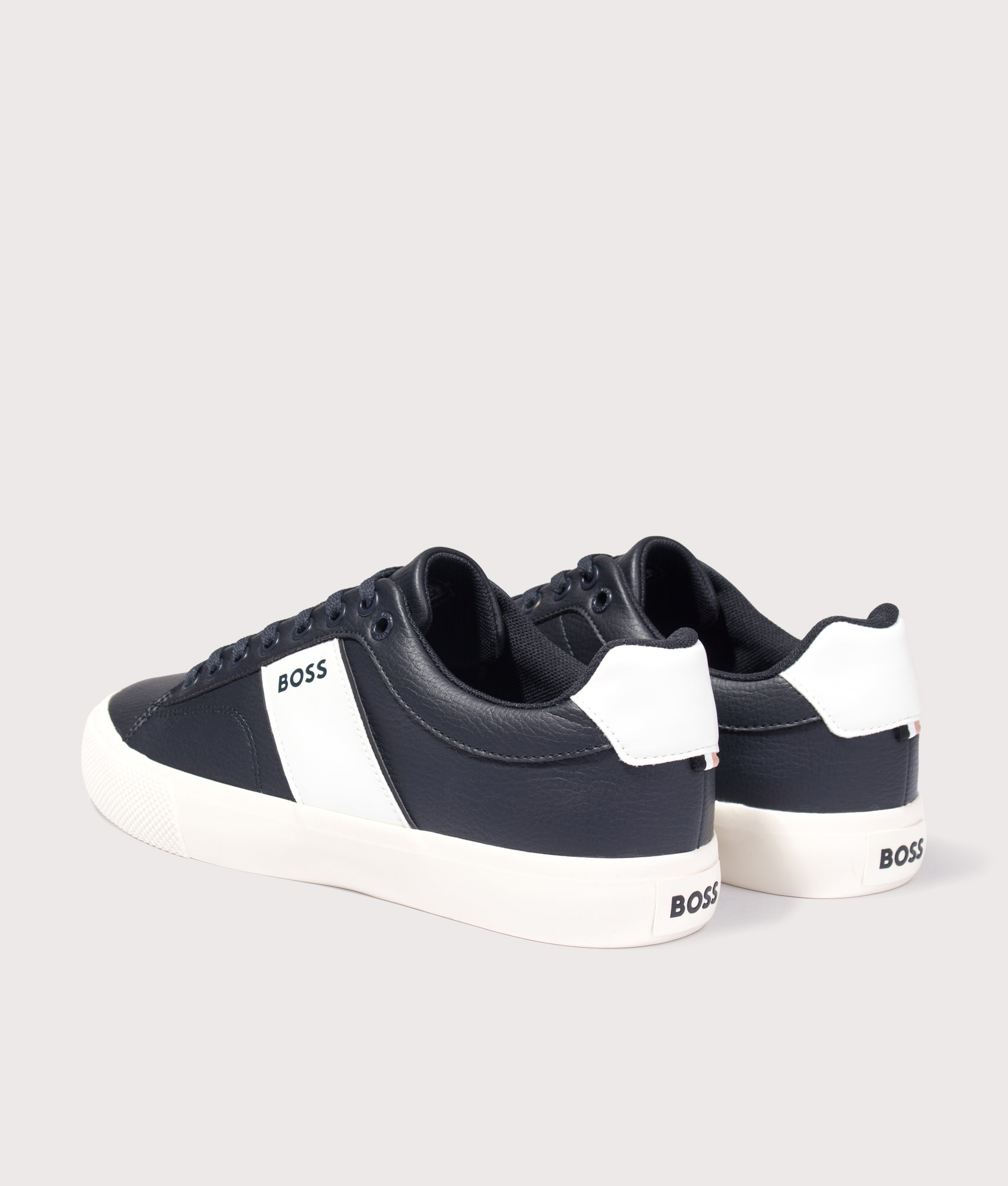 BOSS Aiden Tenn Trainers in Navy at EQVVS Menswear. Angled back shot.