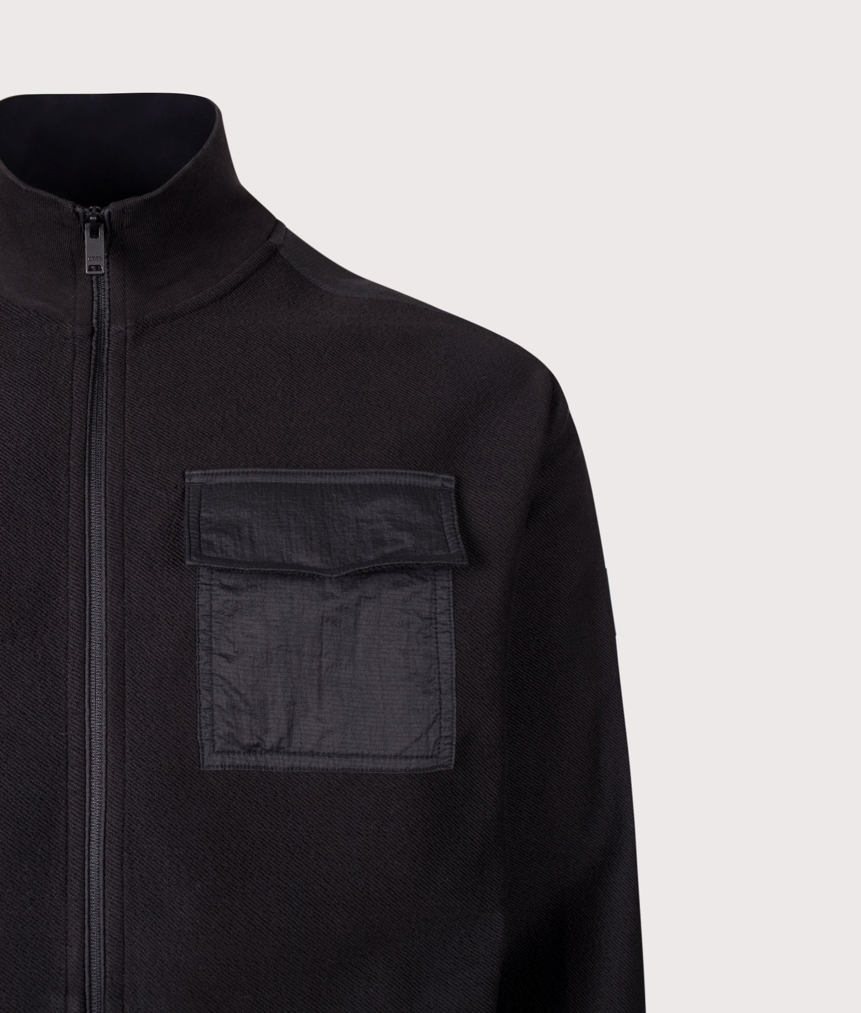 BOSS Relaxed Fit Ze Urban Zip Through Sweatshirt in Black at EQVVS Menswear. Detail shot.
