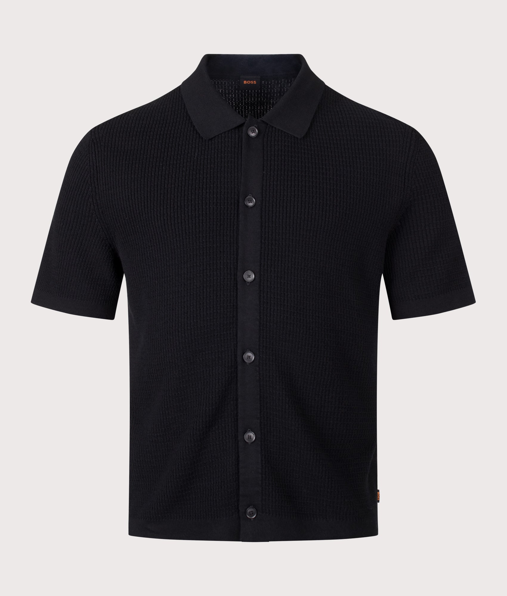 BOSS Relaxed Fit Akepalo Knitted Polo Shirt in Black at EQVVS Menswear. Front shot.