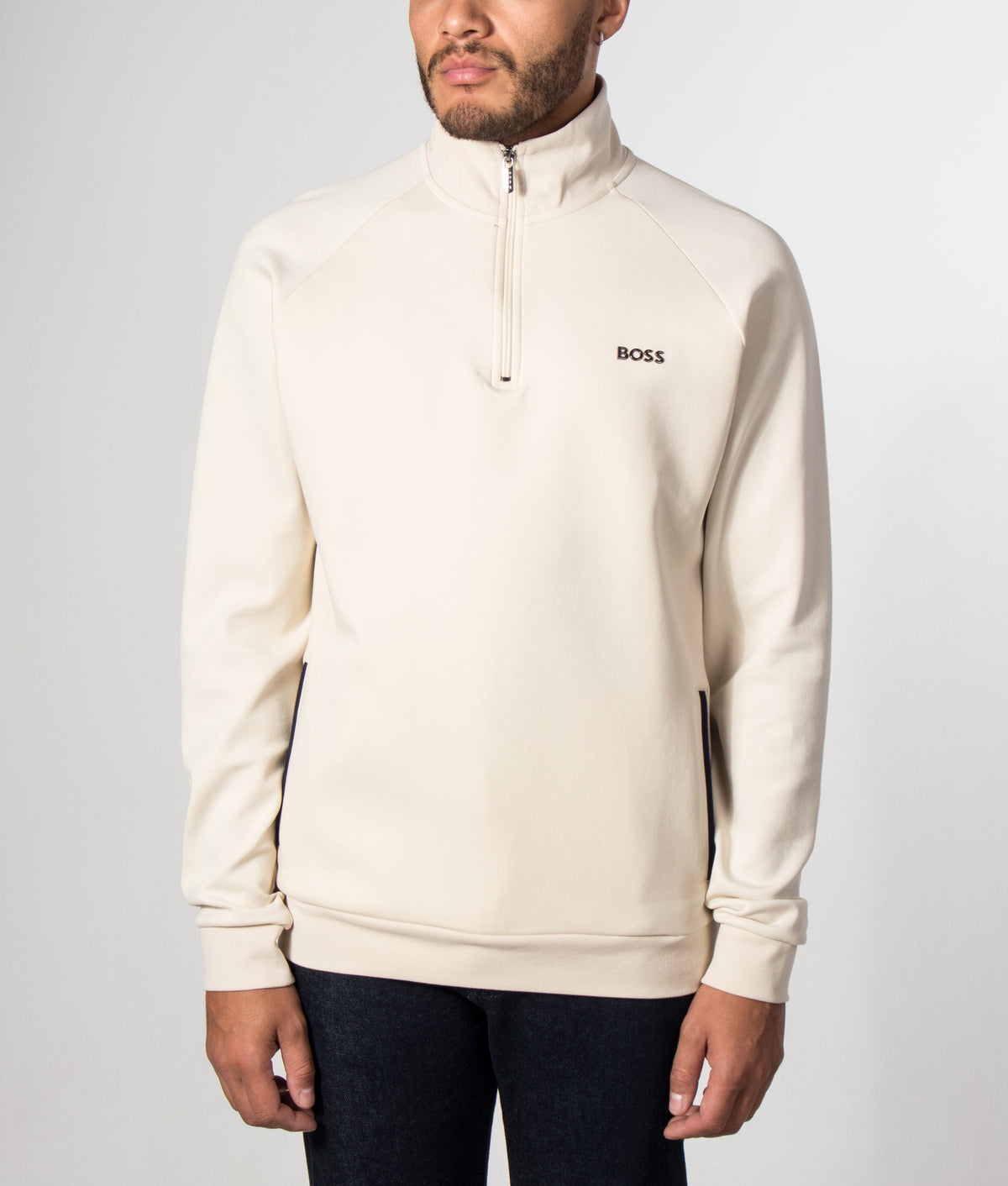BOSS Regular Fit Sense Quarter Zip Sweatshirt in Open White at EQVVS Menswear. Model front shot.